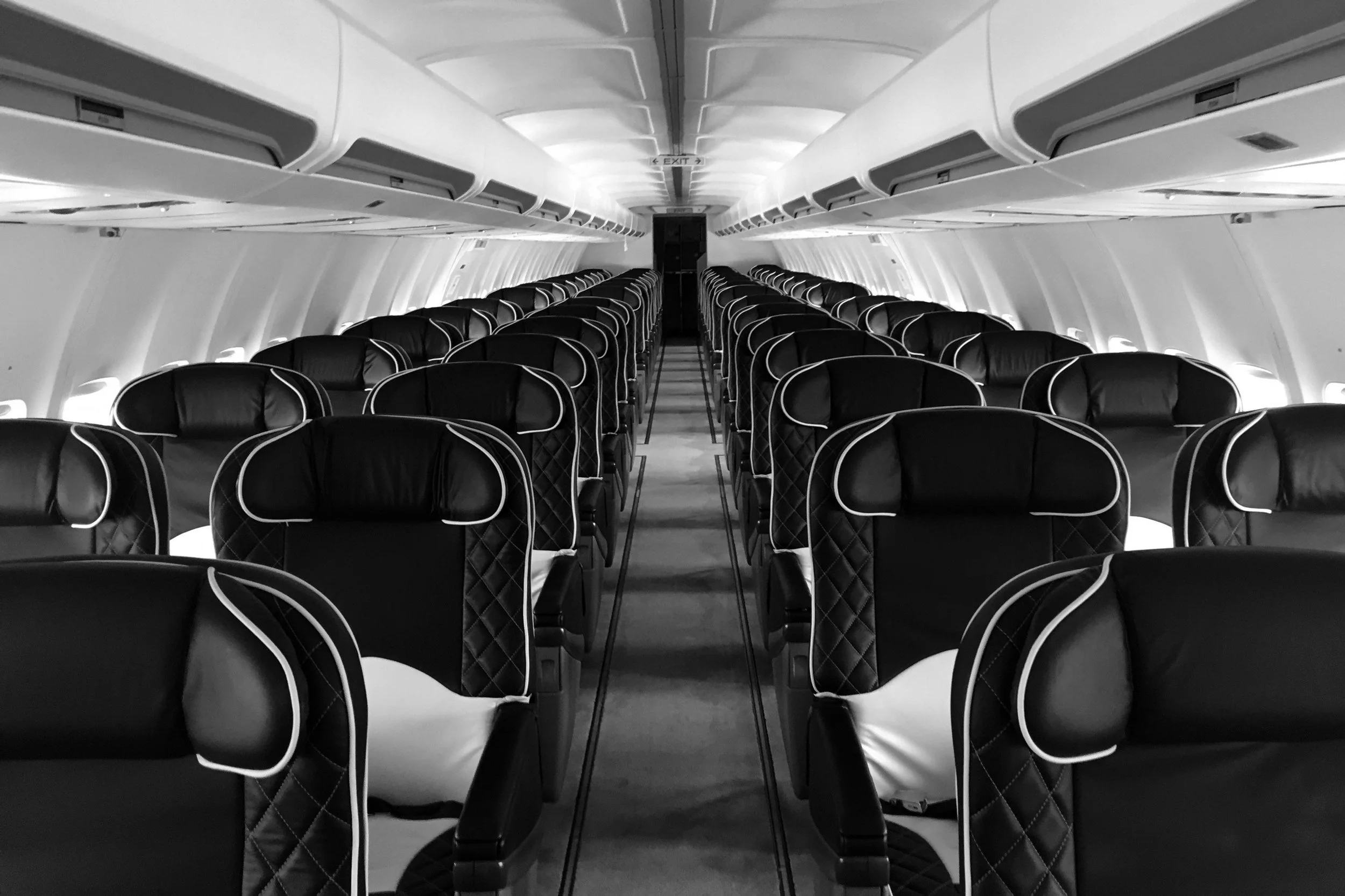 Interior view of a private jet cabin with rows of leather seats