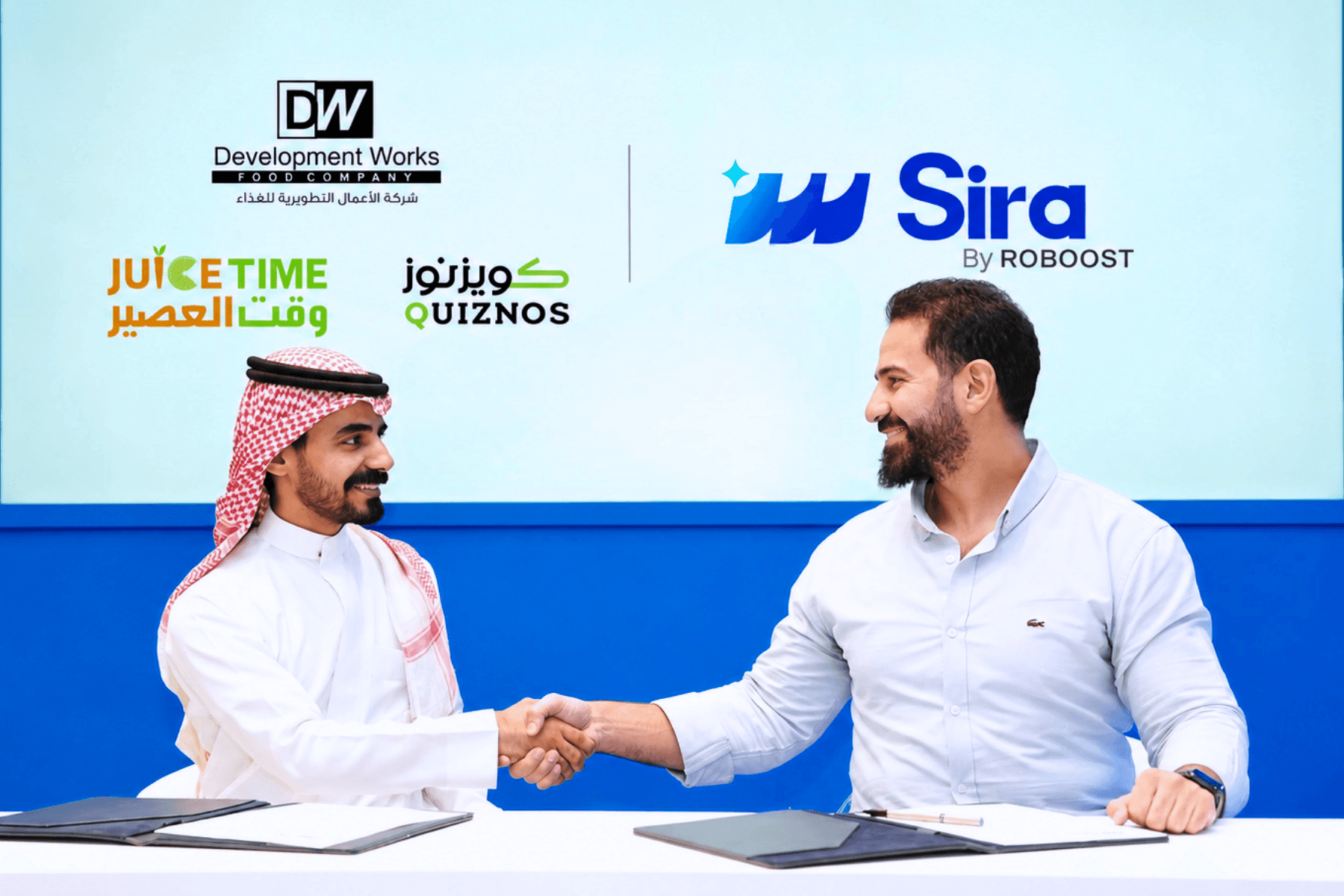 Sira and Development Works Food Company partnership signing in Riyadh for Juice Time and Quiznos customer experience.