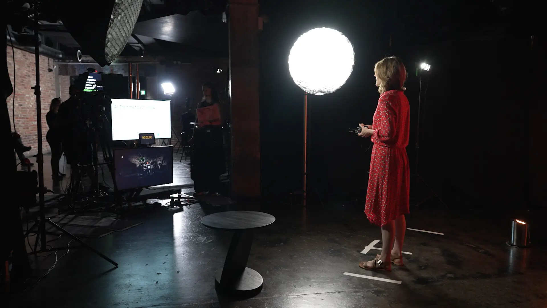 Lighting setup in progress with vertical LED fixtures creating atmosphere in the Wired x Kyndryl studio space.