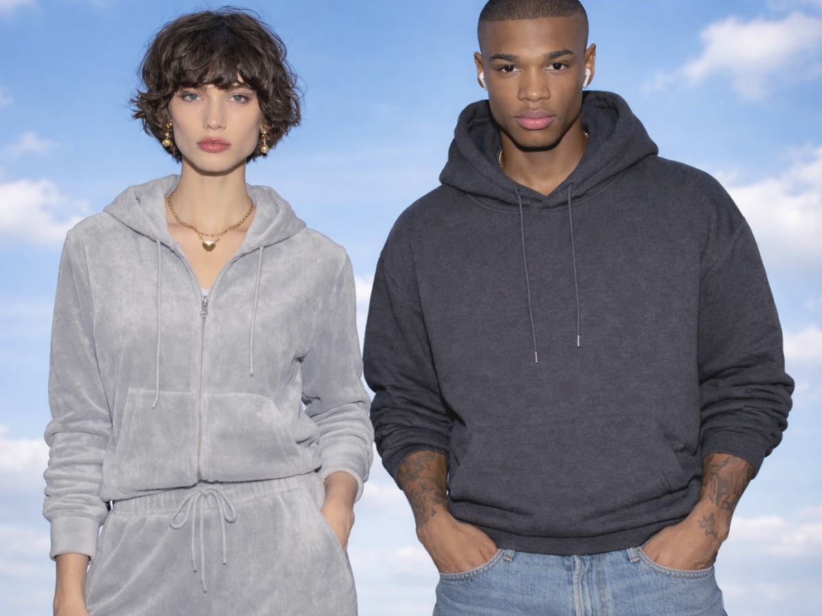 Young man and woman standing against the blue sky and wearing comfortable clothes