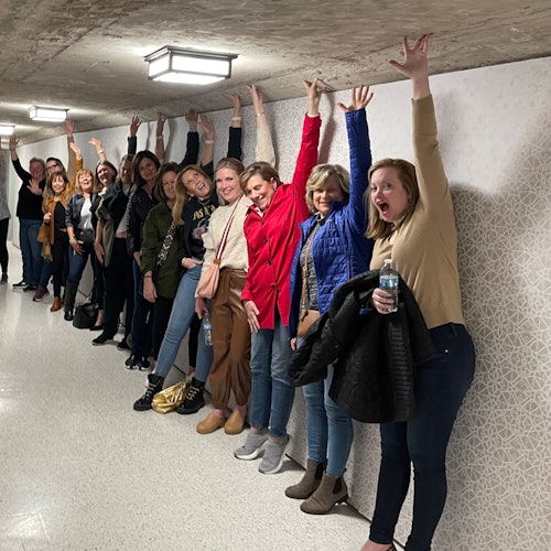 Guests enjoy a fun group photo inside the rustic tunnel during the Astroville Tunnel Tour of Downtown Houston