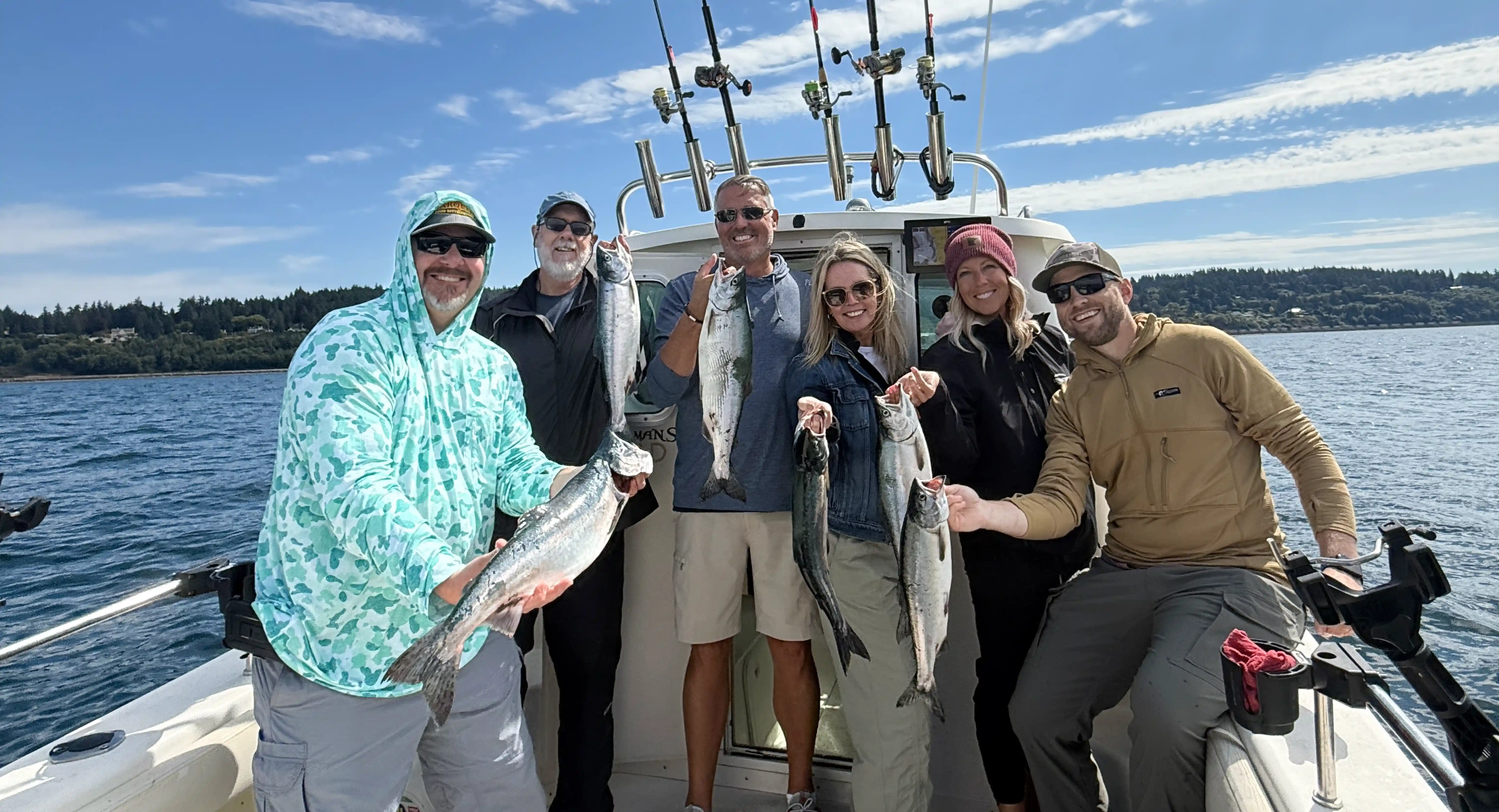 A group of private chater holding their salmon catch