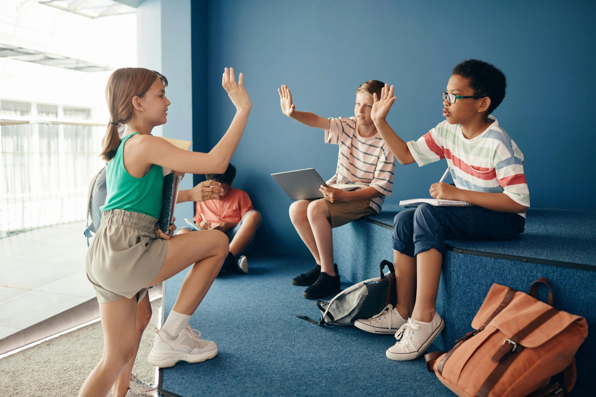 group of kids high fiving each other