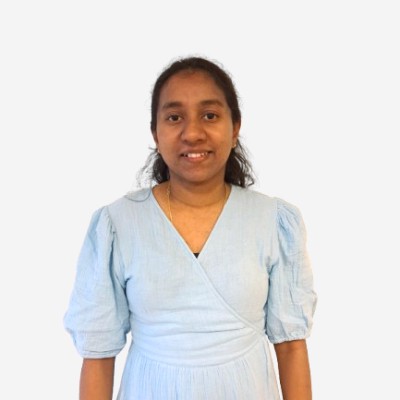 Headshot of employee, Shamini Dabare, on a blue tinted, grey background