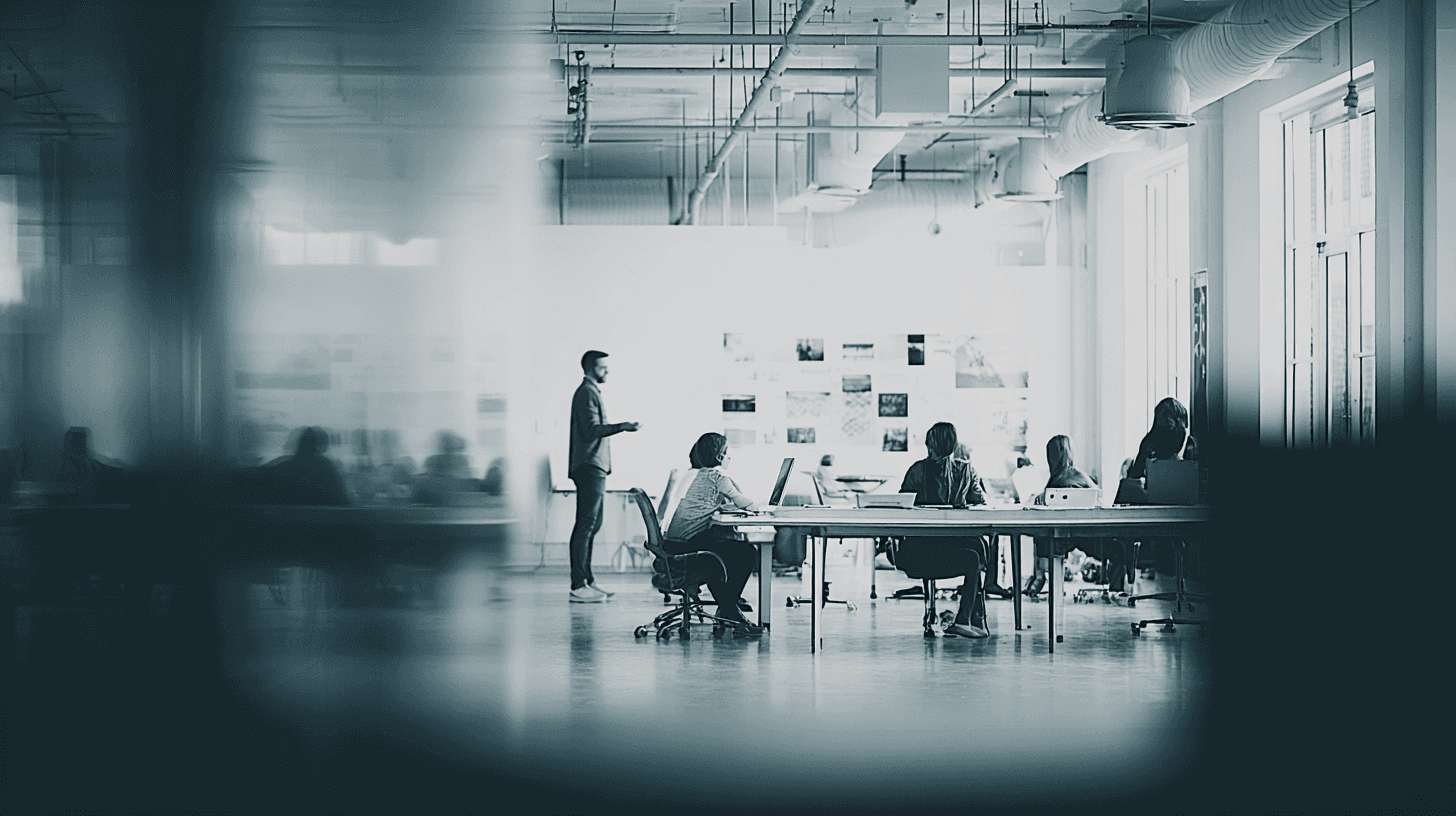 A smiling woman with her arms crossed, standing against a dark green background. She has long, dark hair.
