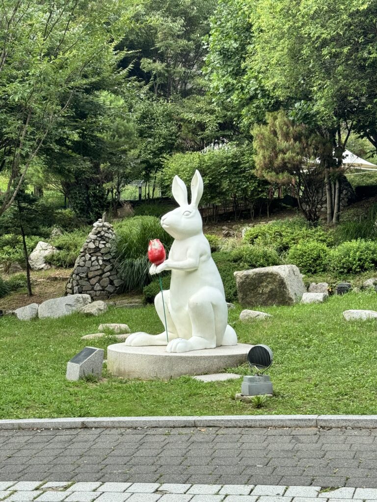 A rabbit with a tulip in hand