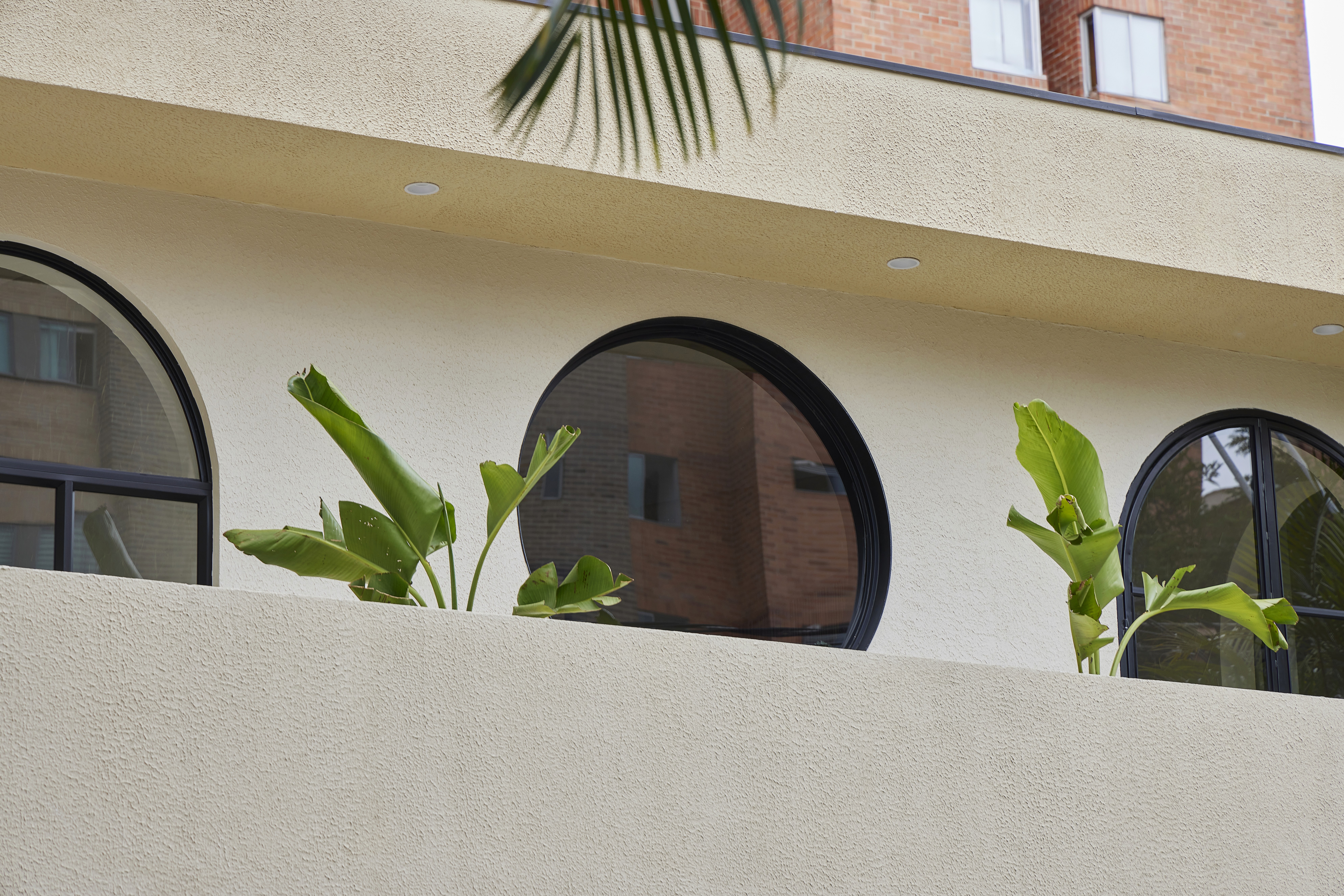 Double-height interior with flowing sculptural forms and warm raking light