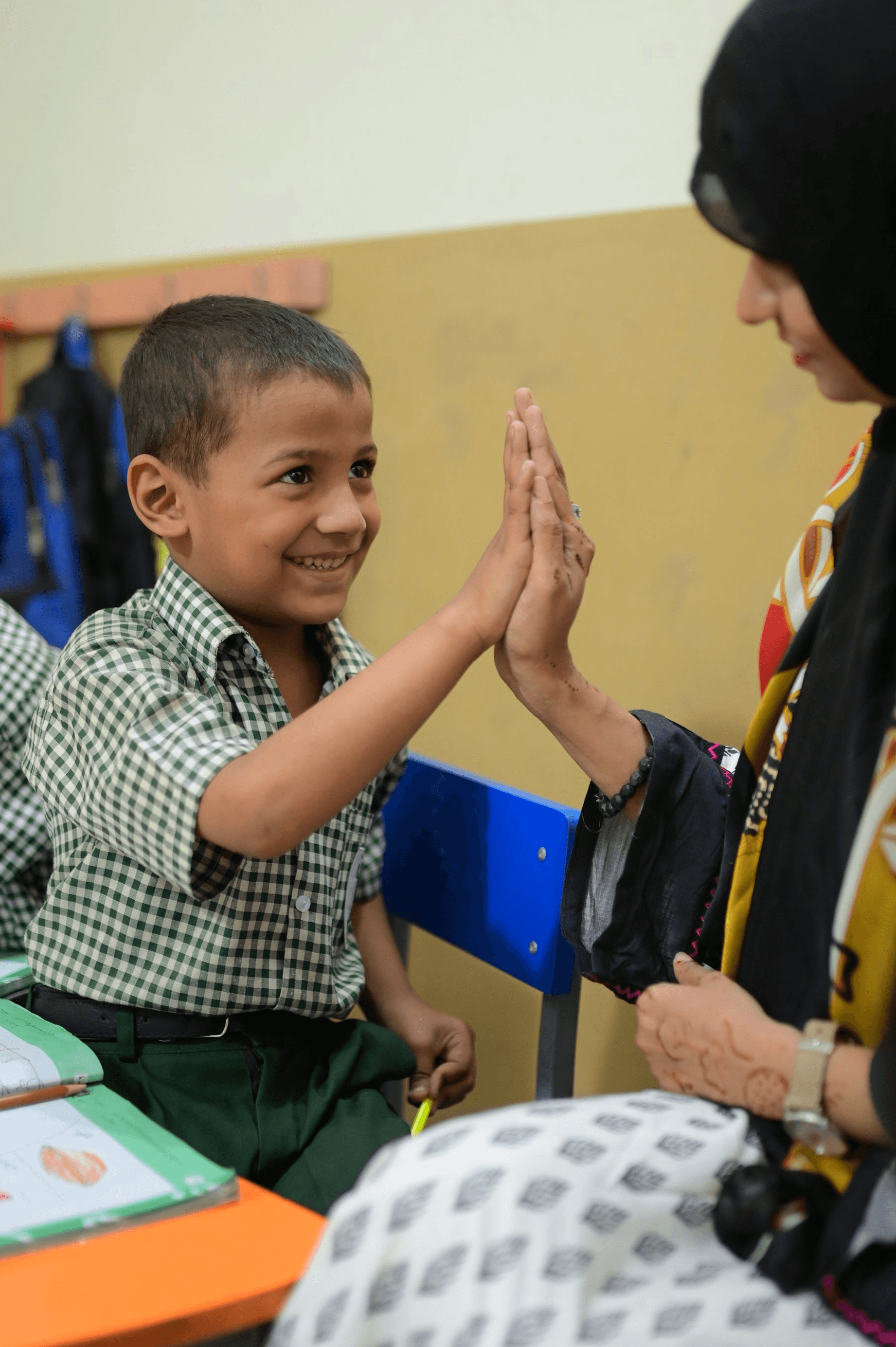 A student is writing in a notebook, focused on the task