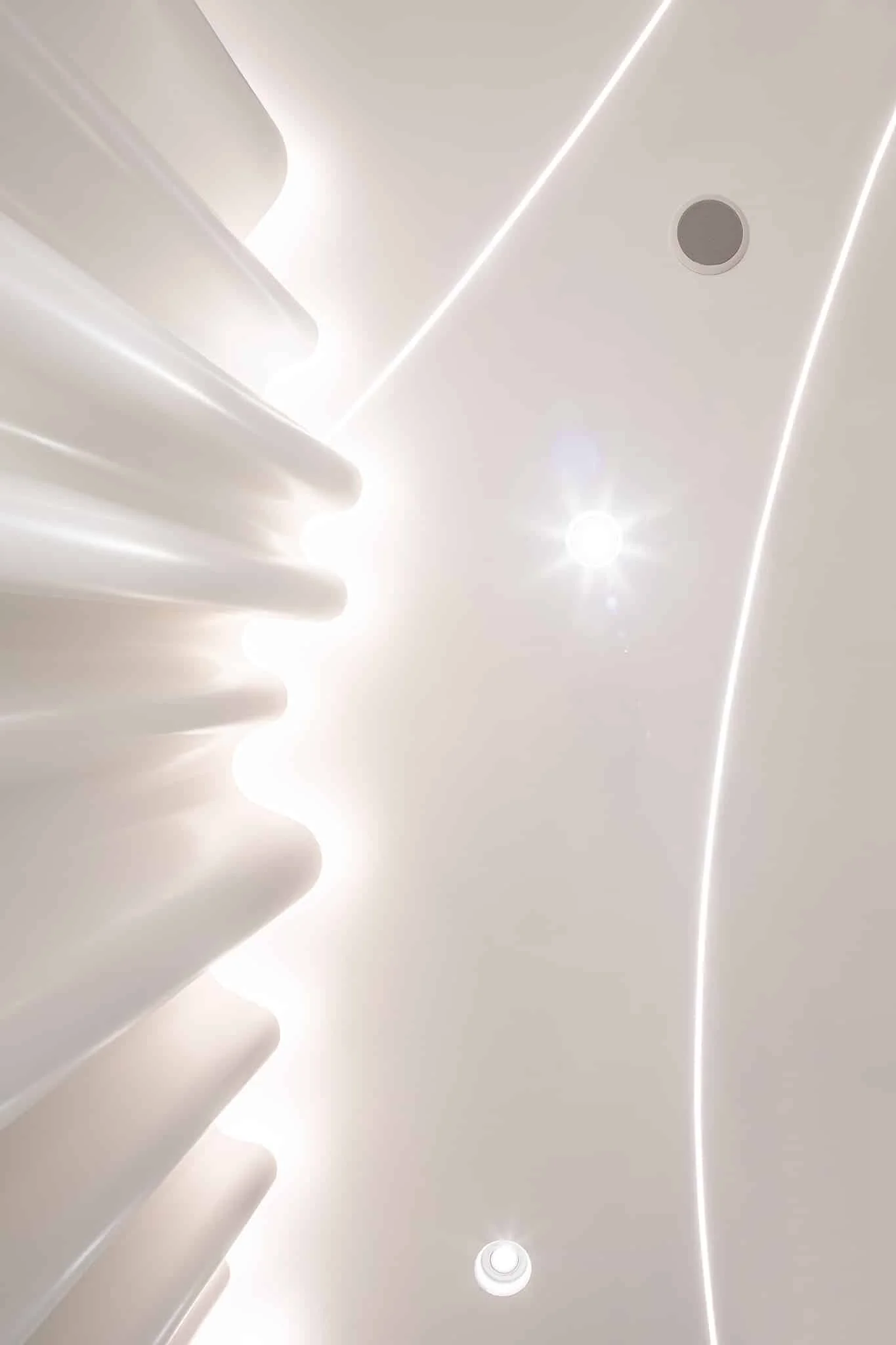 Detail of the curved, backlit fluted wall at COSDENT Siam Square One