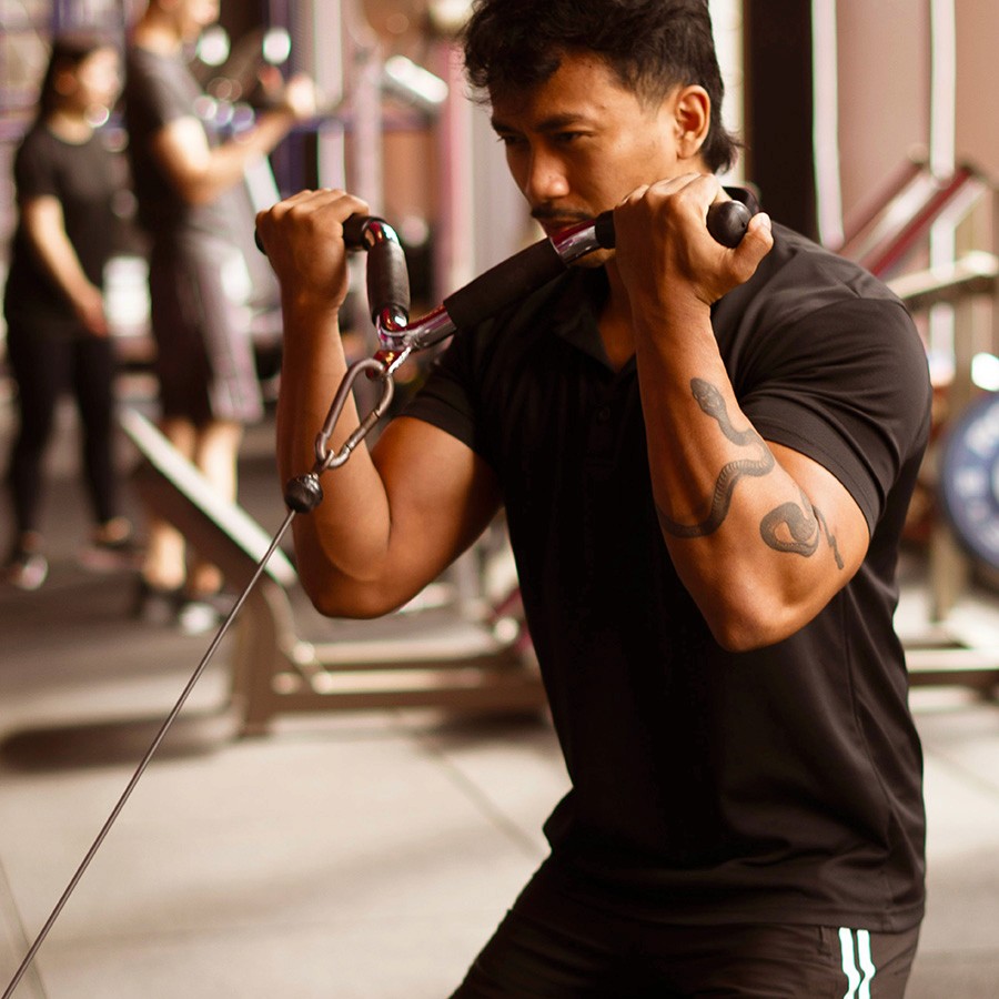 Man Using Cable Machines For Bicep Workout