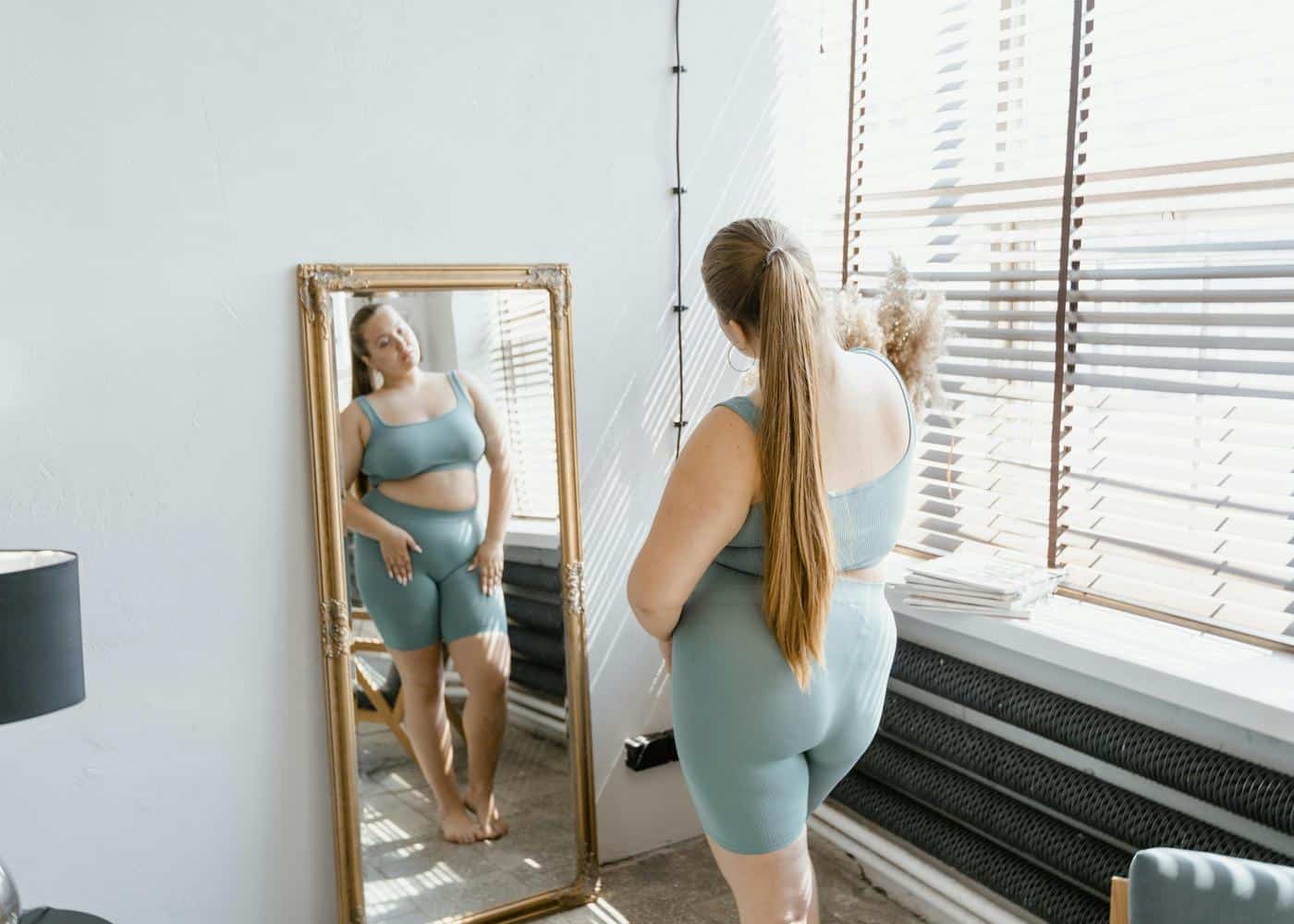 Woman looking at herself in the mirror
