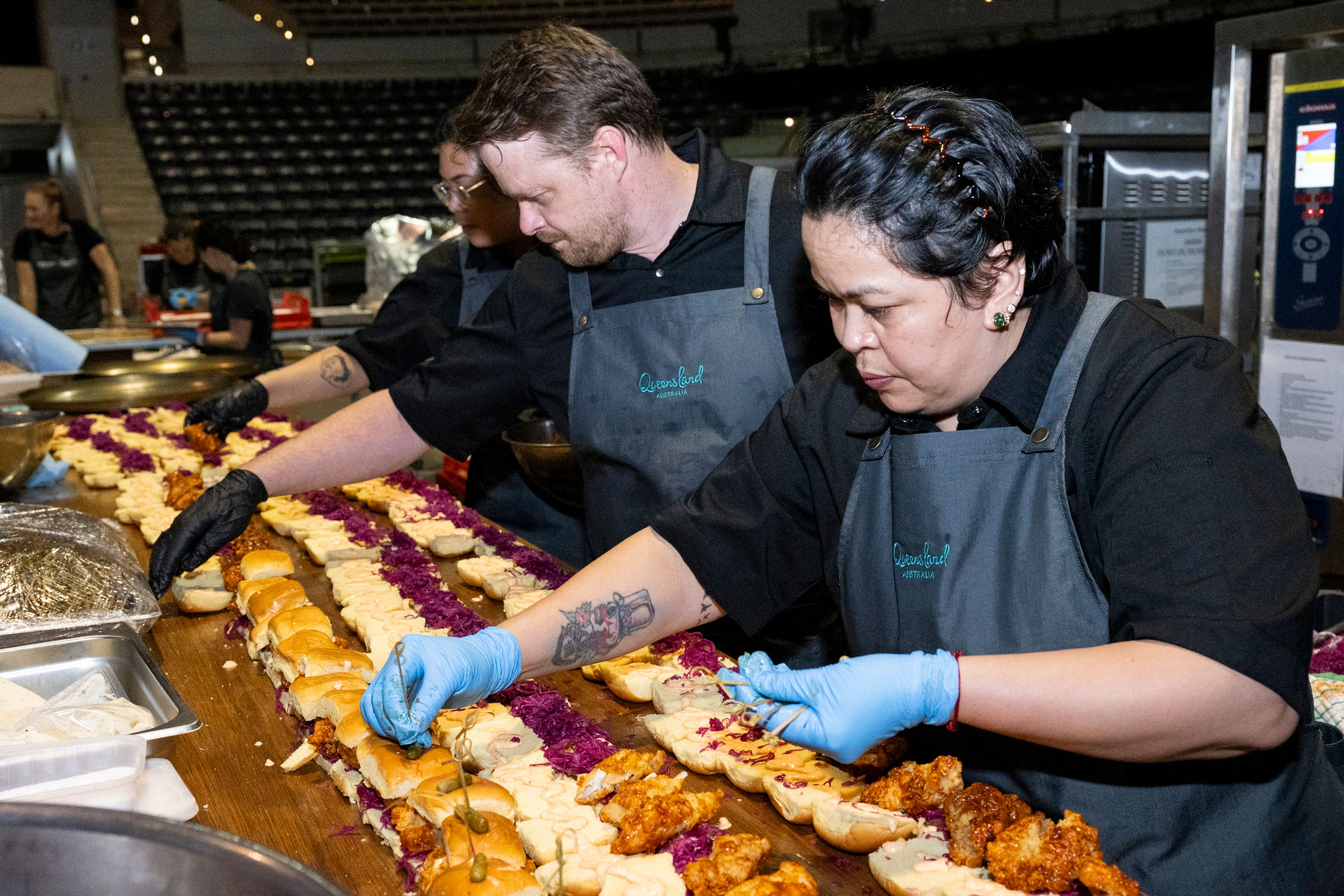 Chef's prepping Korean Fried Chicken Burgers at the Australian Tourism Exchange 2025