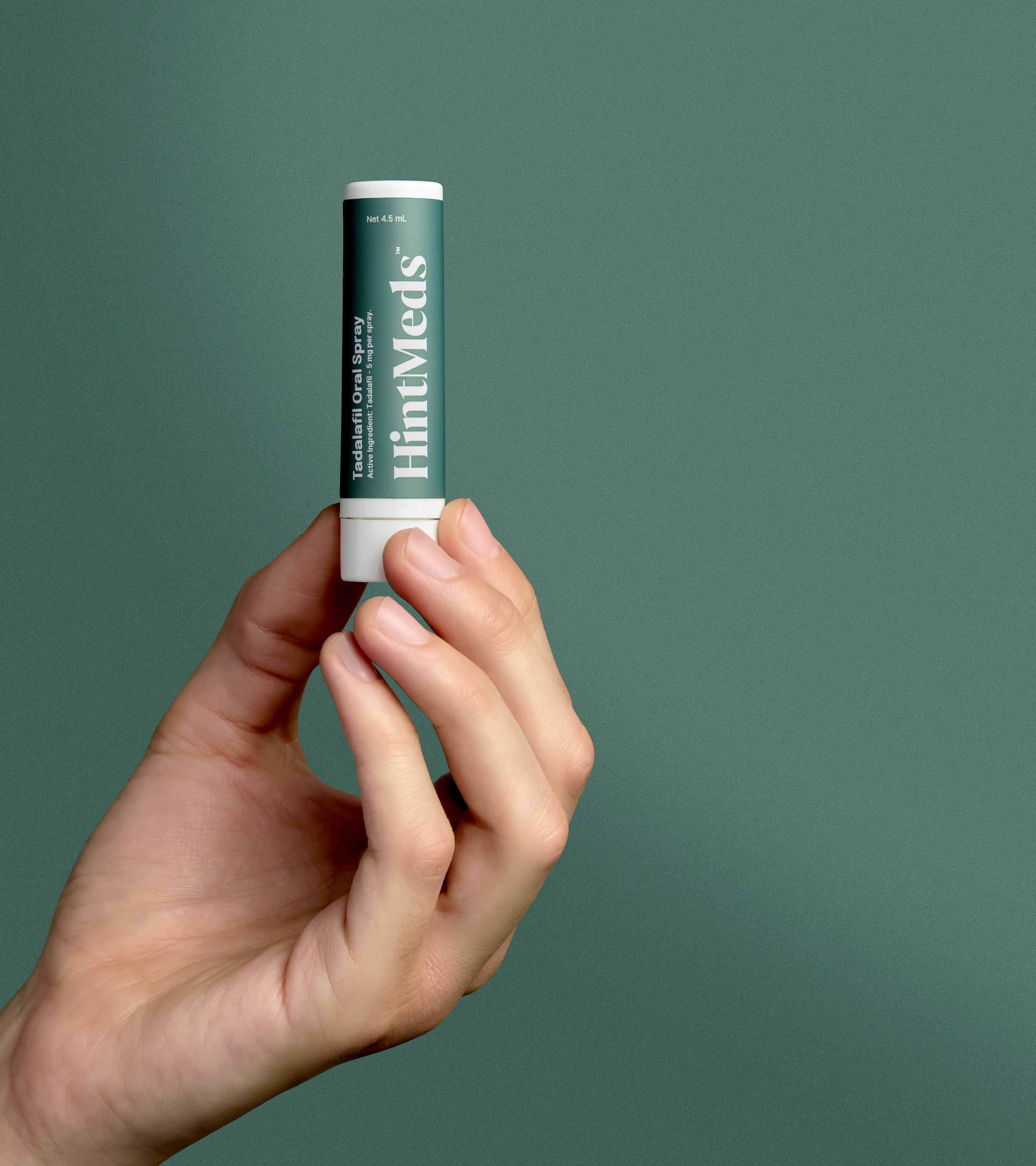 hand holding Hintmeds spray bottle 