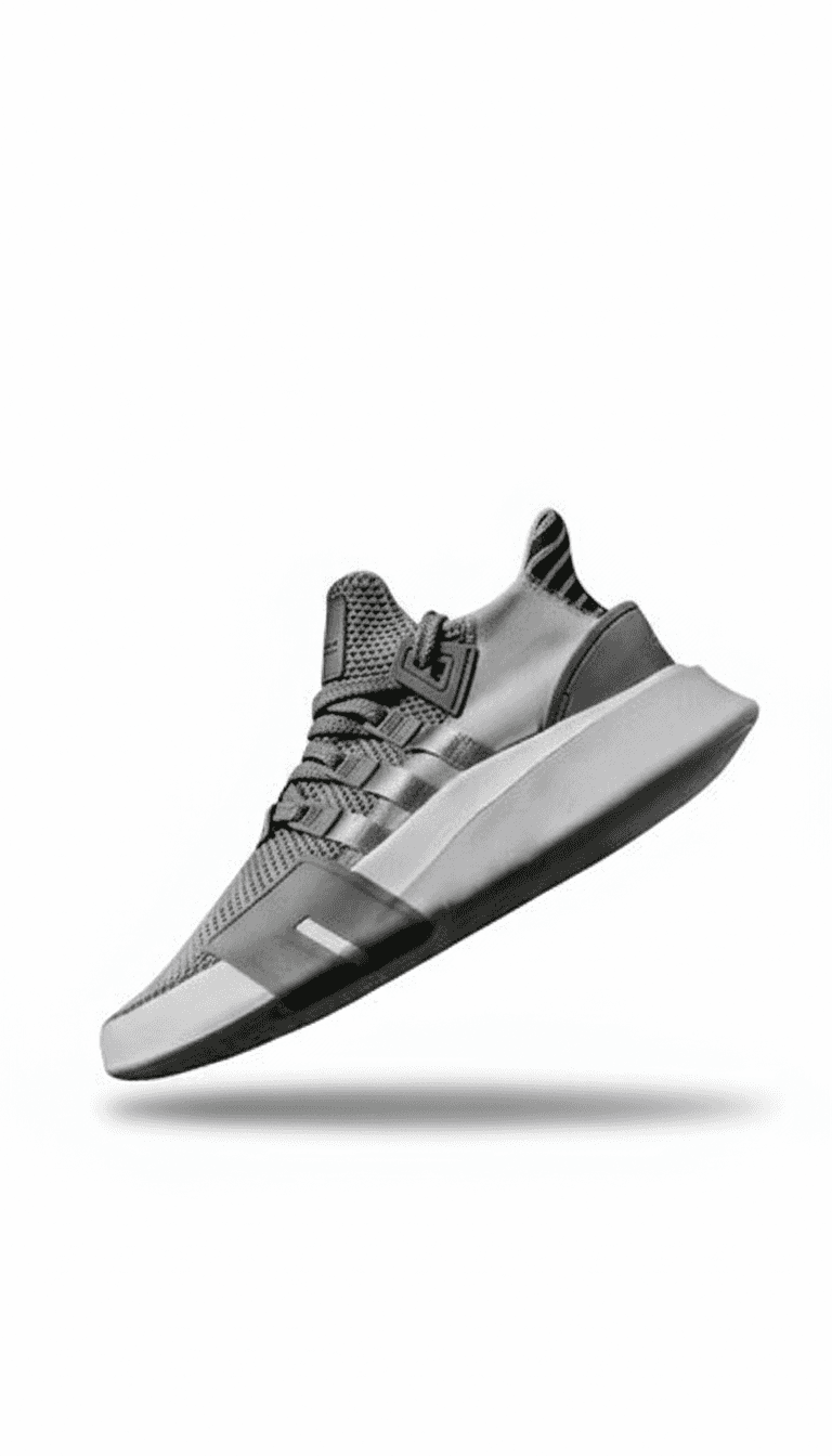 Floating white track shoe with bright orange accents and metal spikes, presented in a clean studio environment with a soft shadow.