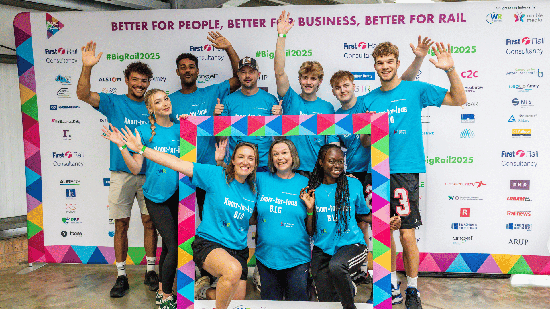 Outdoor team-building event with participants wearing matching blue shirts, taking part in inflatable obstacle courses and games, smiling and cheering, with the words 'ENTER A TEAM' in large bold white and green text across the image.