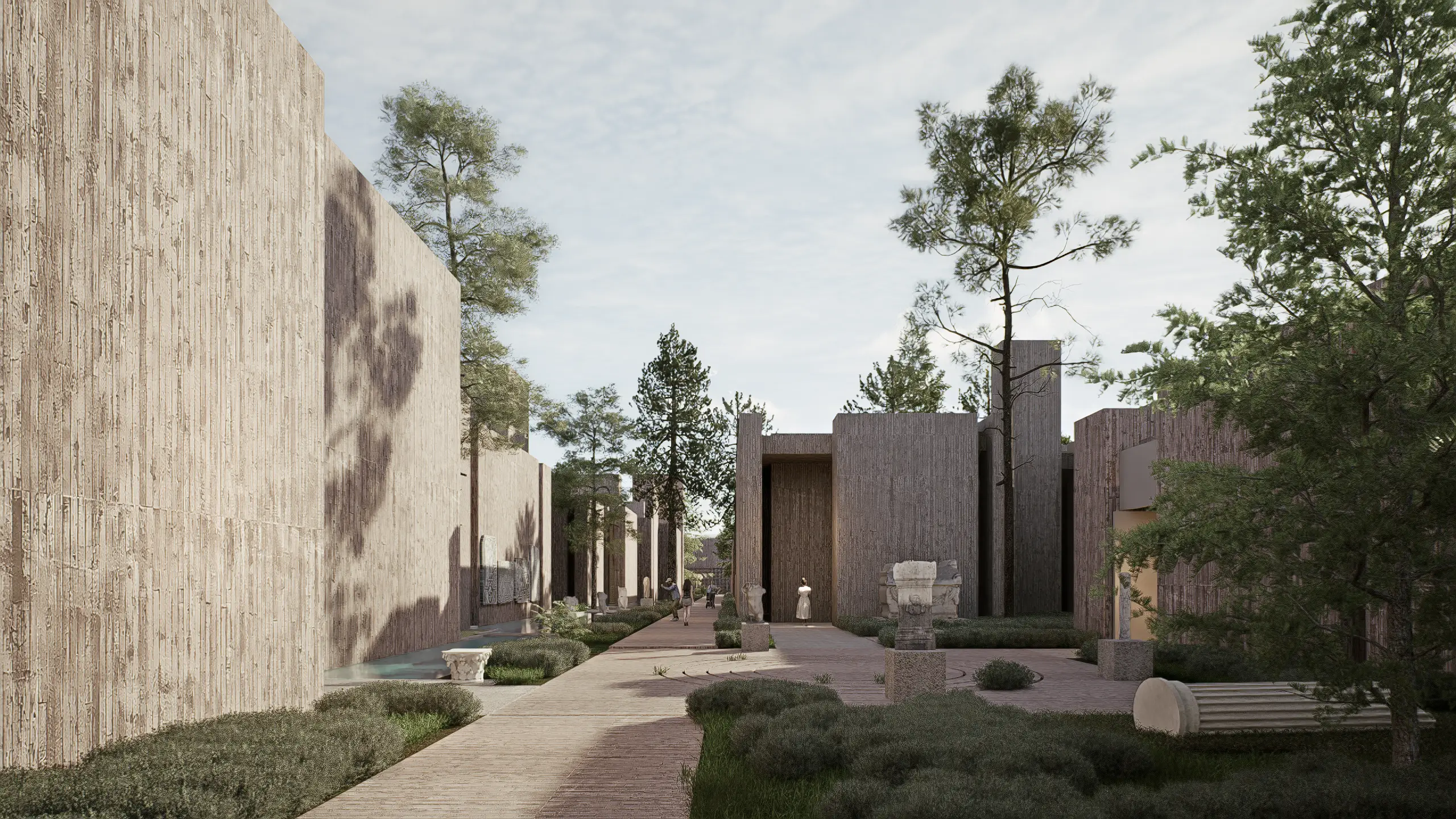 Long museum path lined with tall textured walls and displayed sculptures
