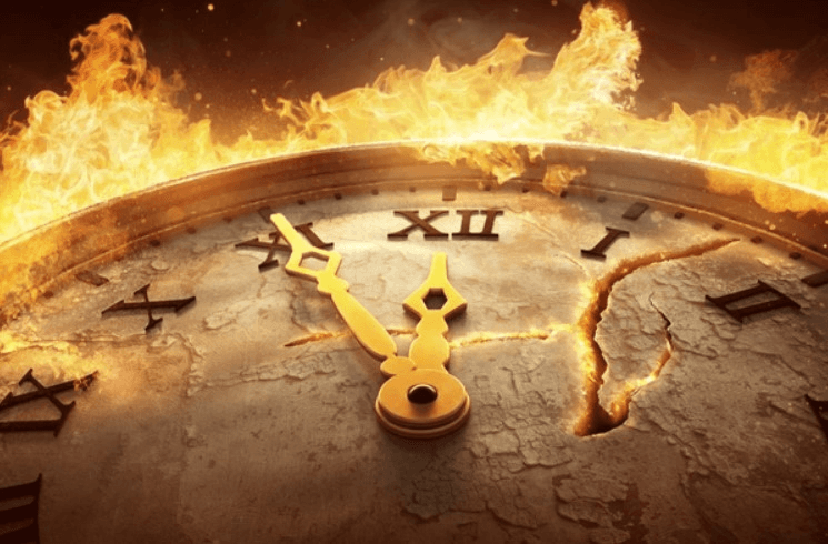 A person with curly hair sits at a desk, working on a laptop in a cozy, well-lit environment.