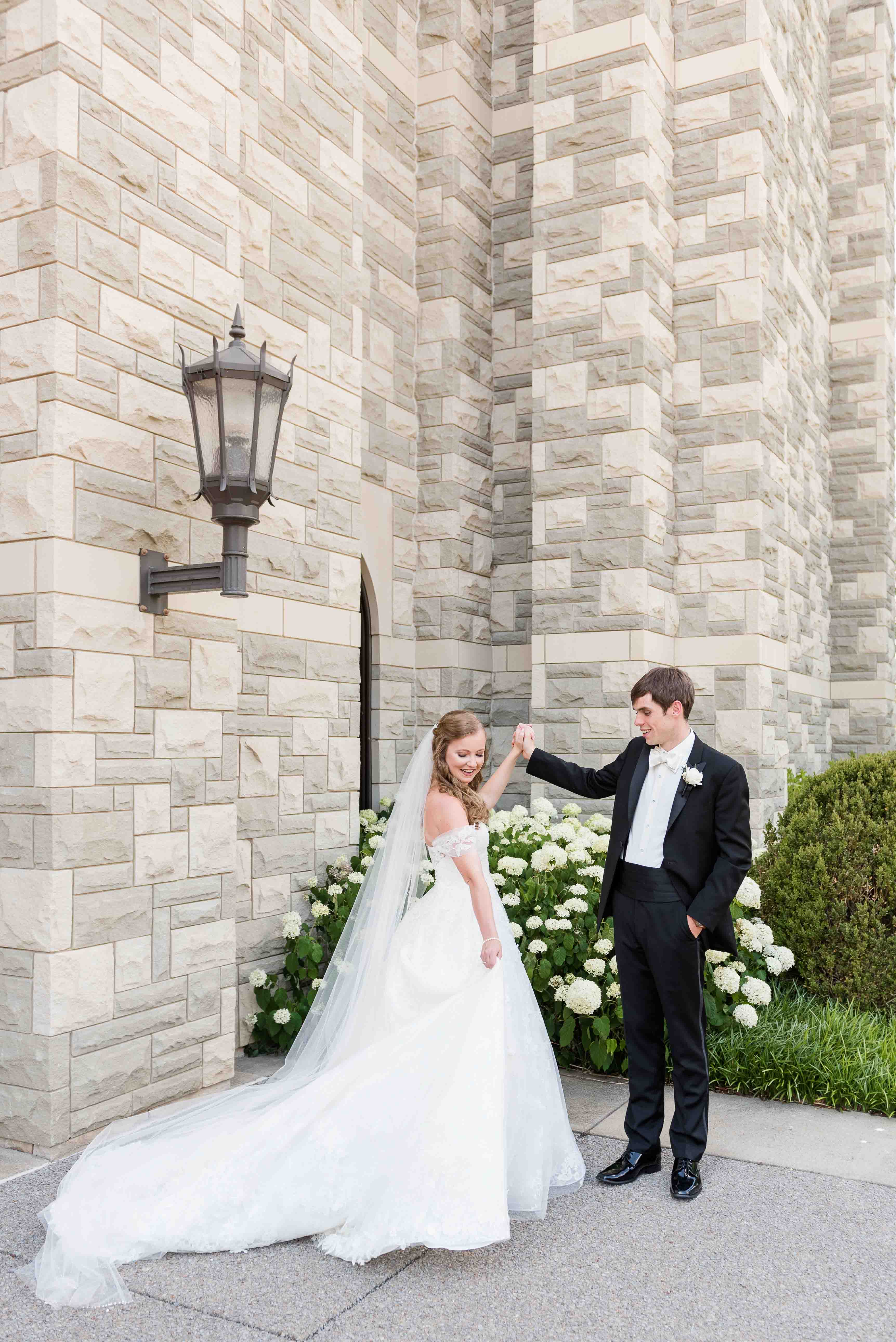 Bride and groom portrait at Covenant Presbyterian Church by a hydrangea bush in Nashville, Tennessee.