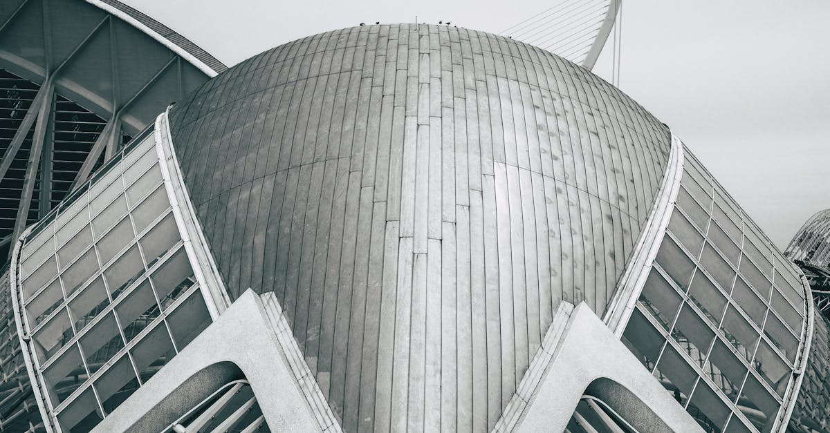 A striking futuristic building with a metallic dome and glass panels.