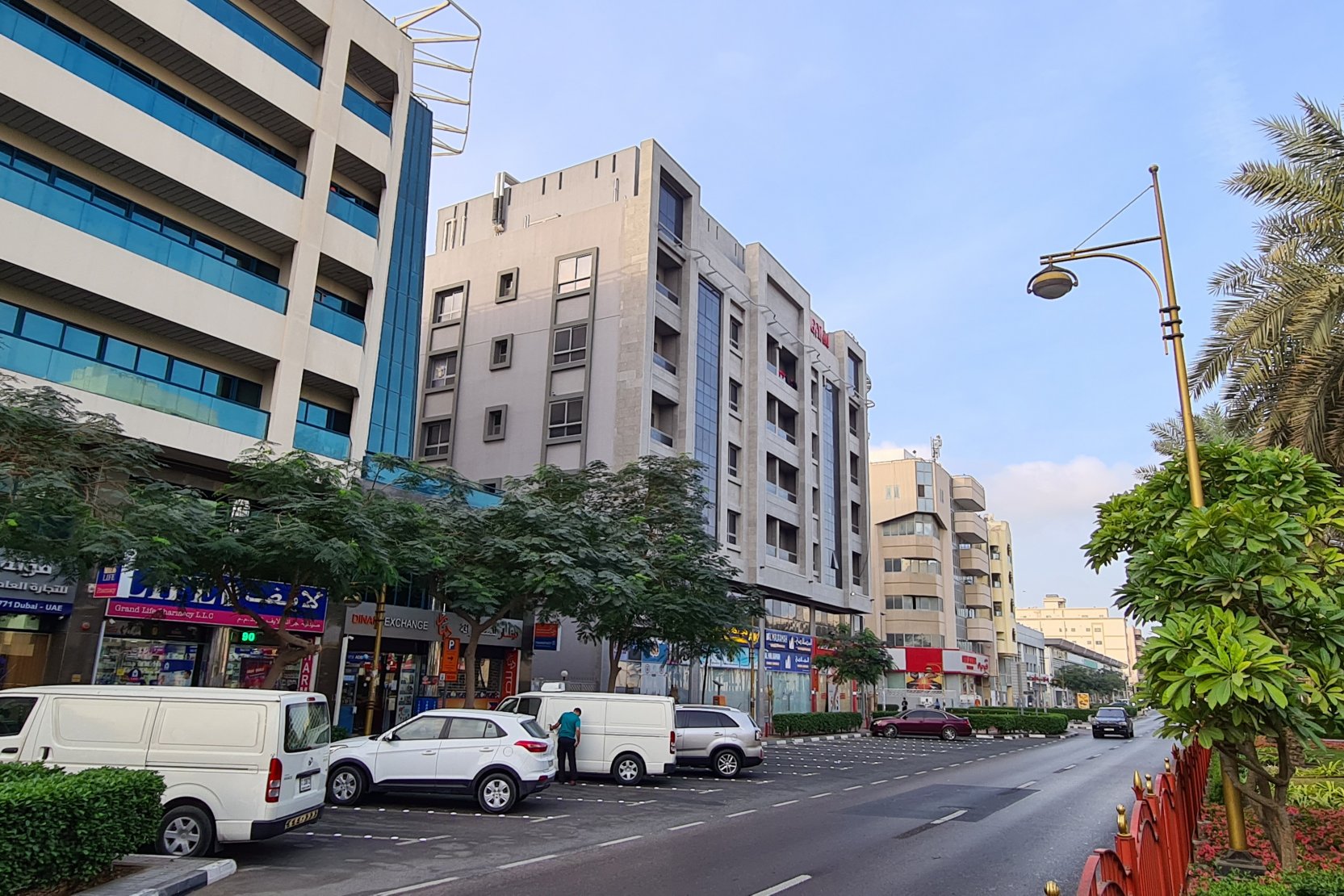Vibrant street in Muteena Dubai with local shops. Real estate agency providing tailored property search services.