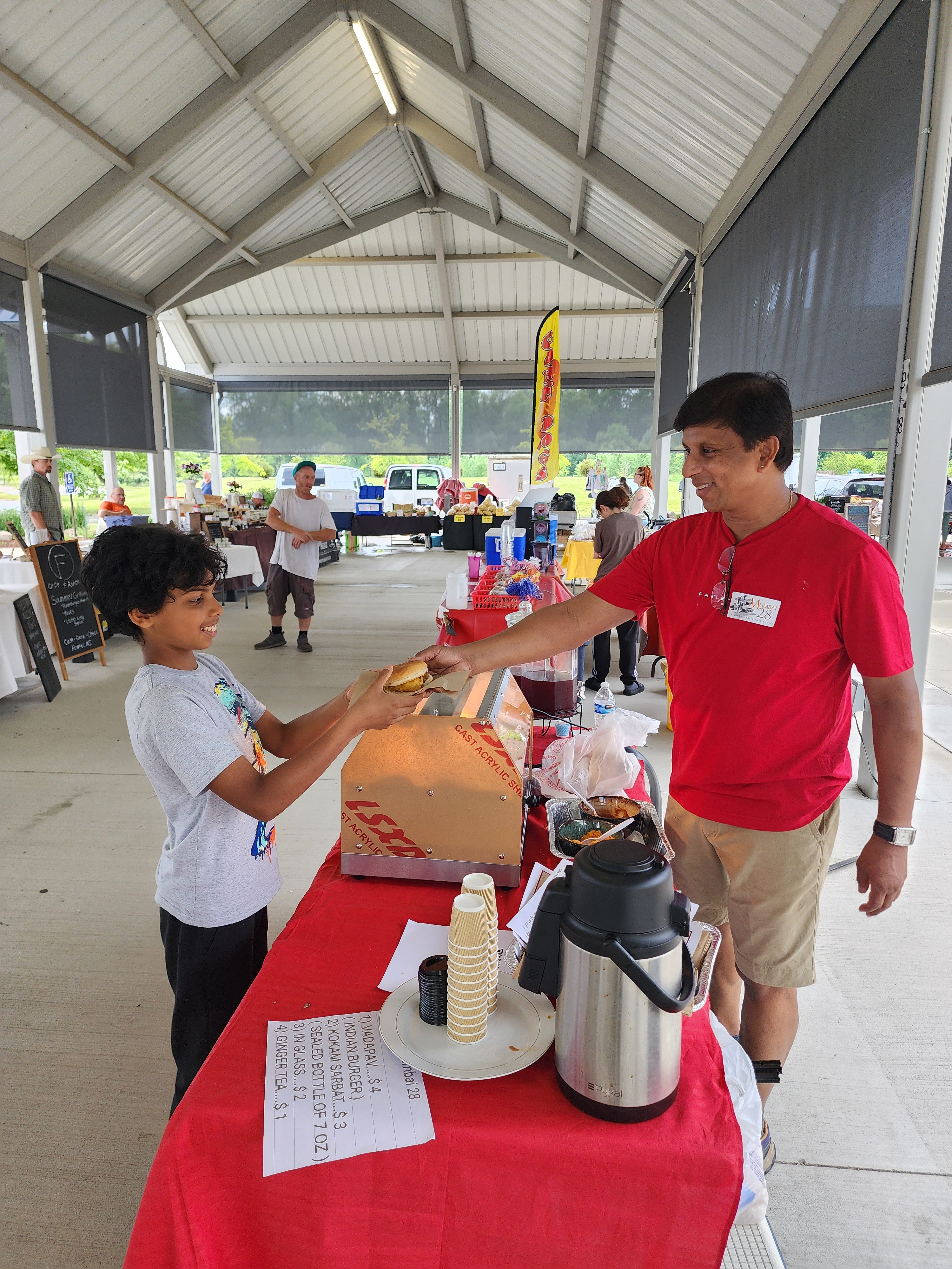 An image of the founder serving food to customers