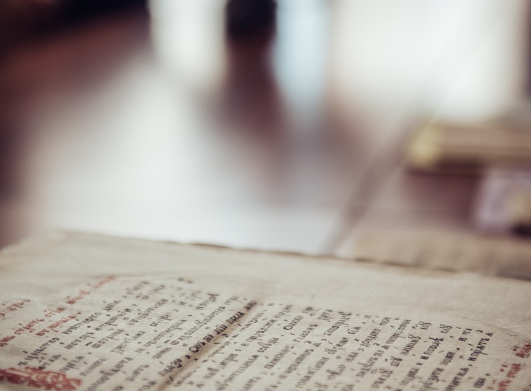 An open handwritten manuscript on a wooden table
