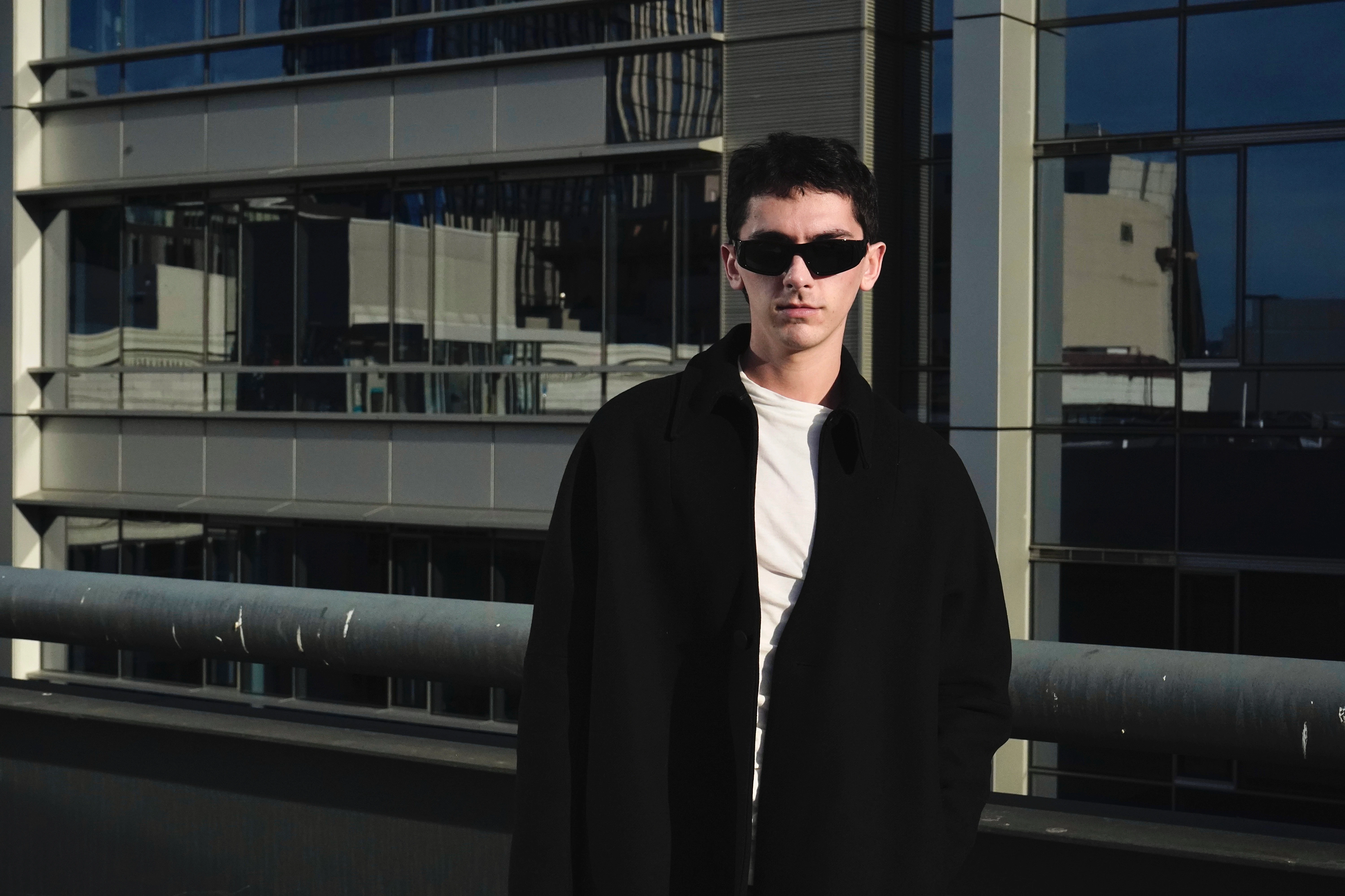 GQ model that's too cool in sunglasses and skyscraper reflections