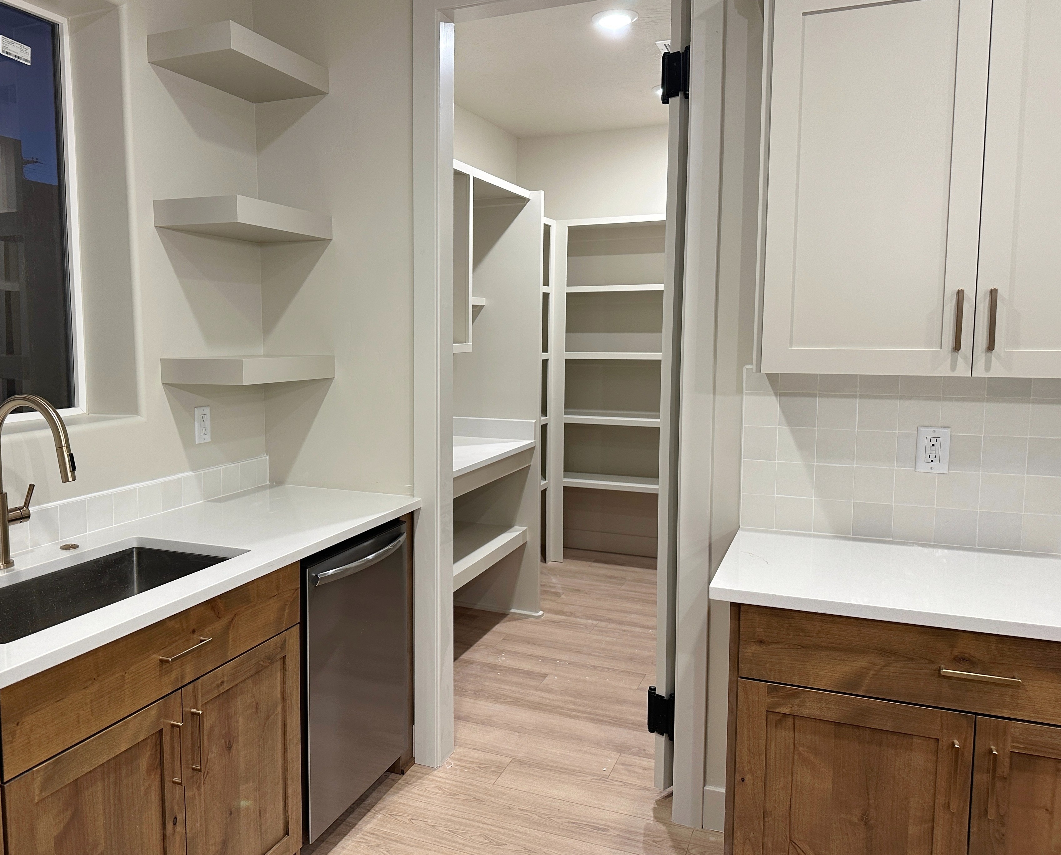 Walk-in pantry at The View at Falcon Ridge in Hurricane, Utah, with custom shelving and ample storage for kitchen essentials.