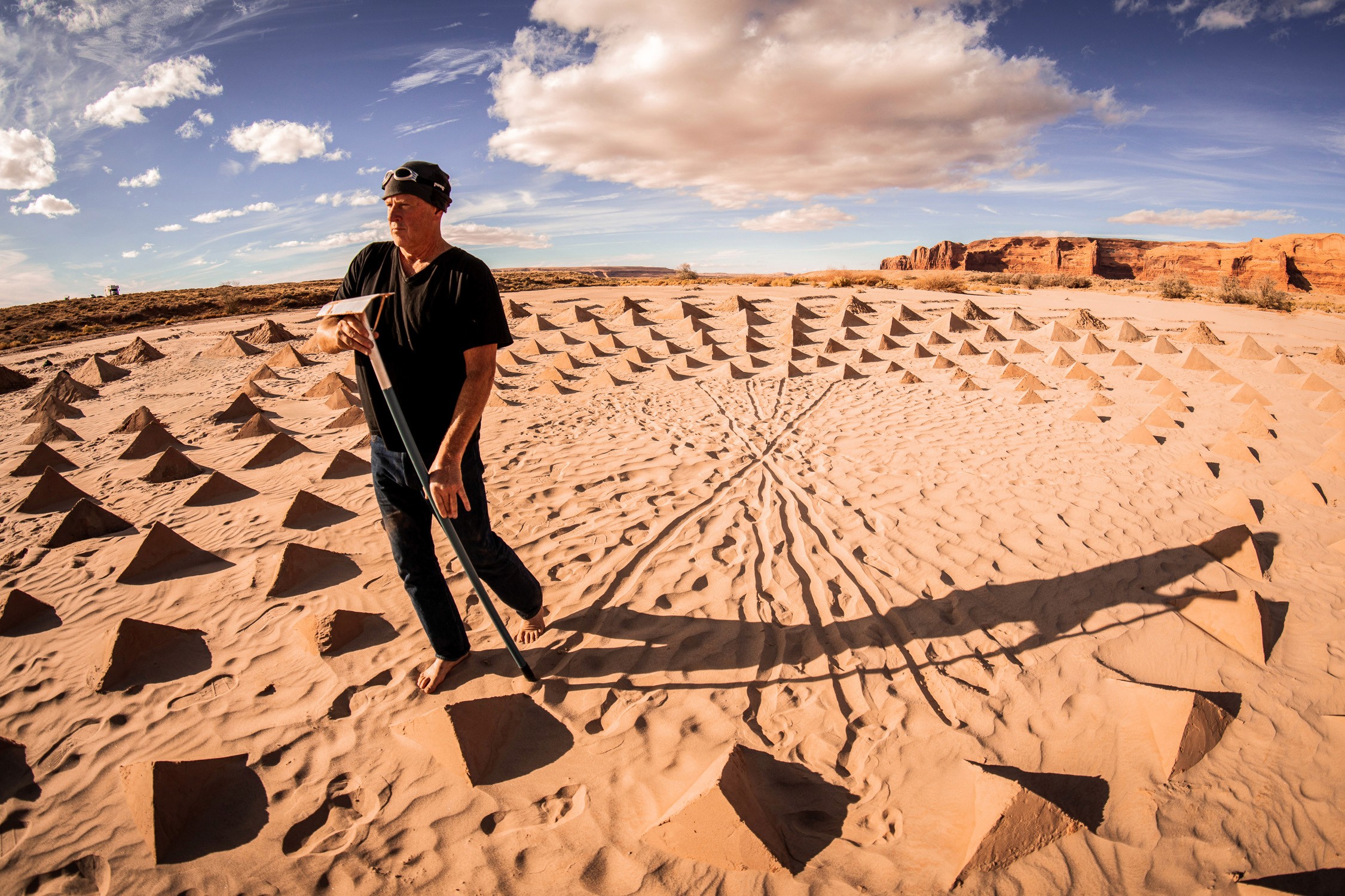 Land artist Jim Denevan drawing lines in the sand while constructing the land art for Owen Brown’s ARIZONA music video