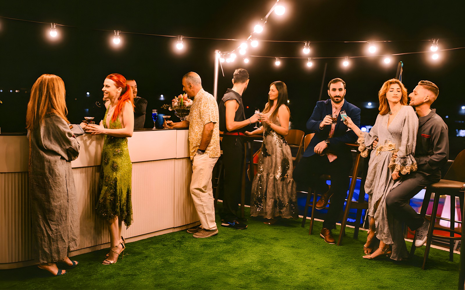 Crociera serale sulla Riviera di Atene con ospiti sul ponte, skyline della città visibile sullo sfondo.