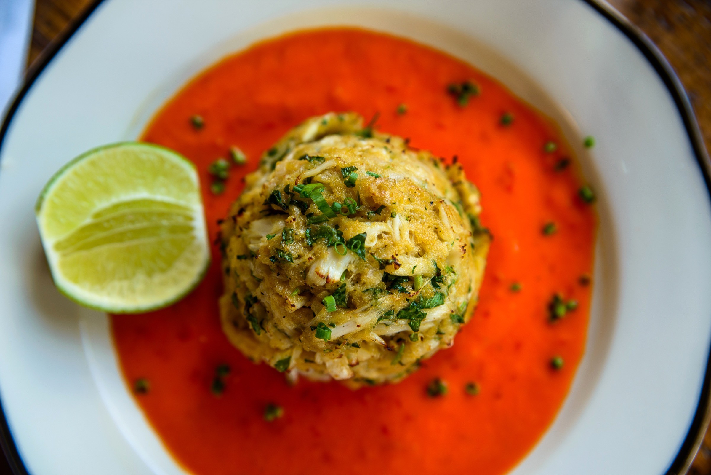 Editorial photograph of a plated crab cake