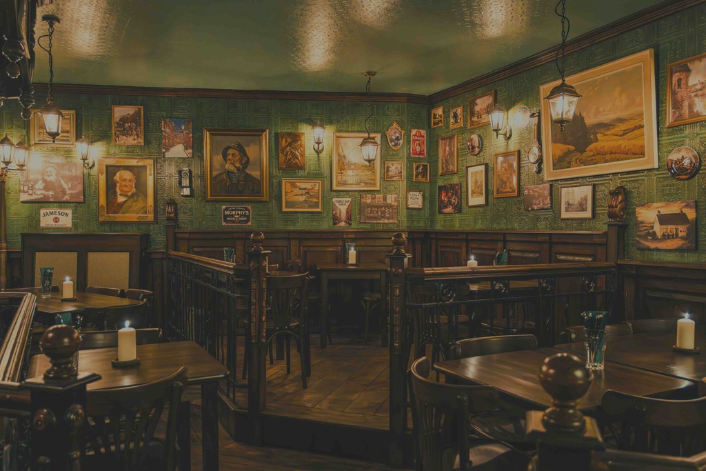 A dimly lit bar scene with warm yellow lights, creating a cozy and inviting atmosphere.
