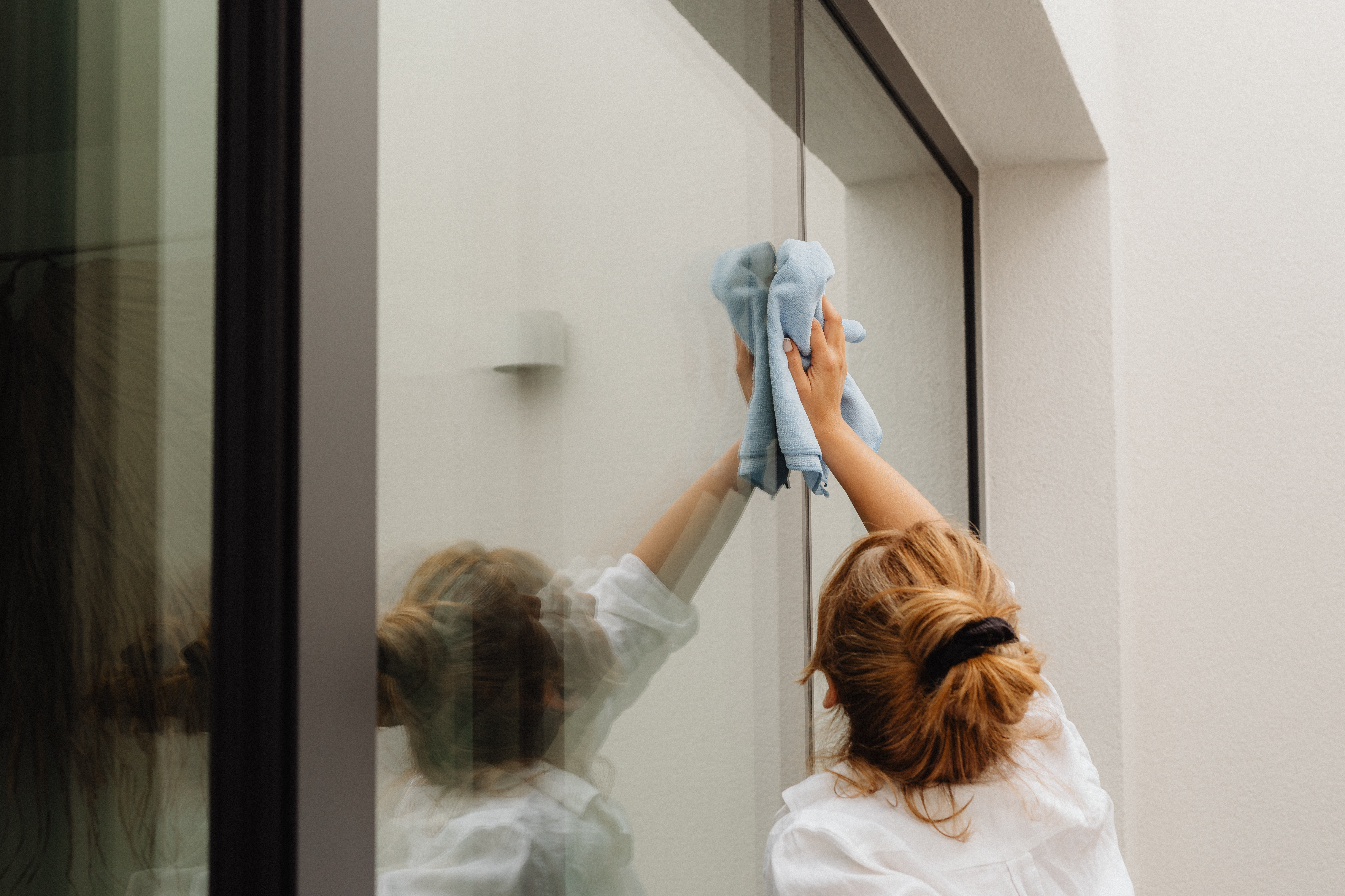 Woman wiping glass with cloth