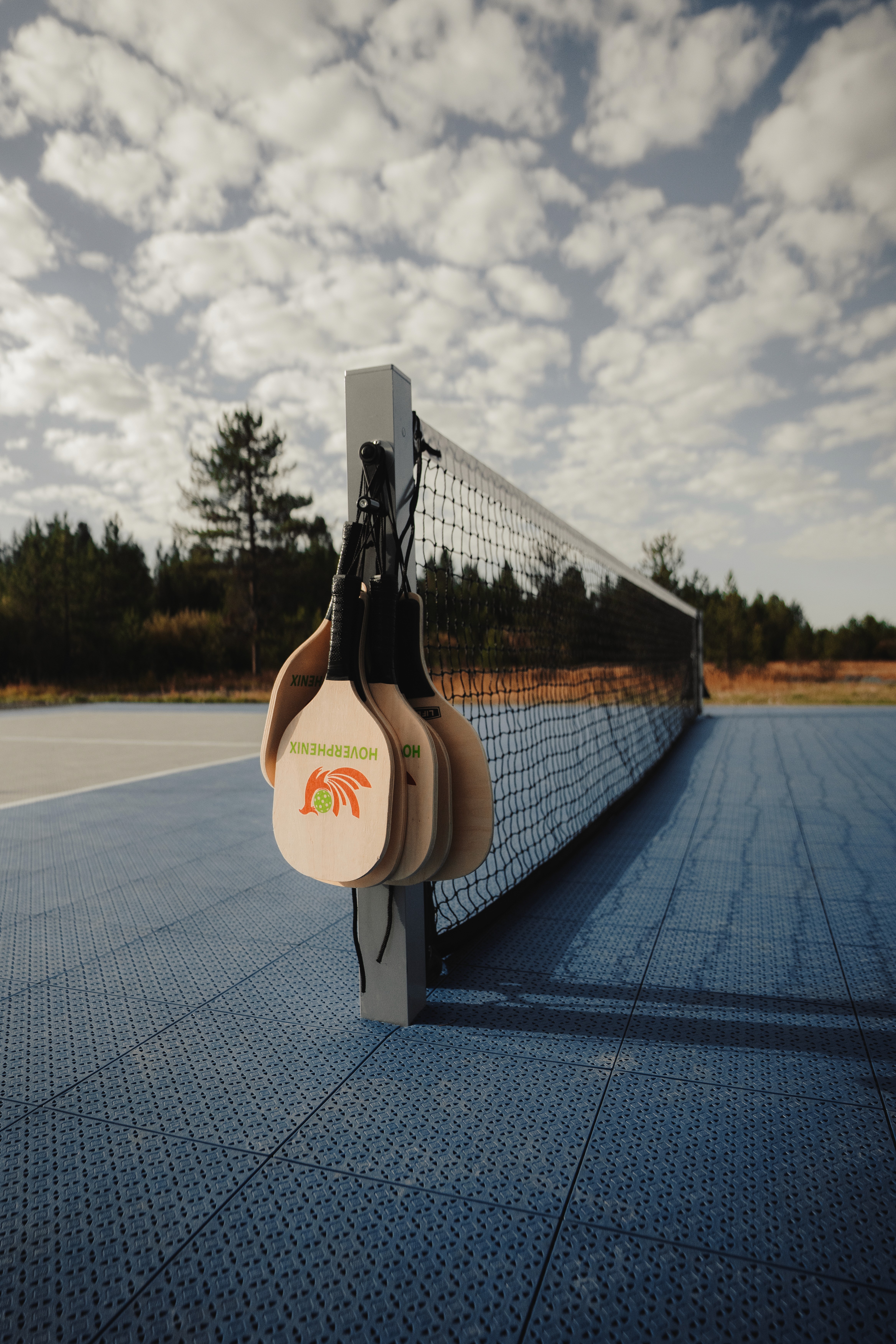 Pickleball paddle and ball rest on the court.