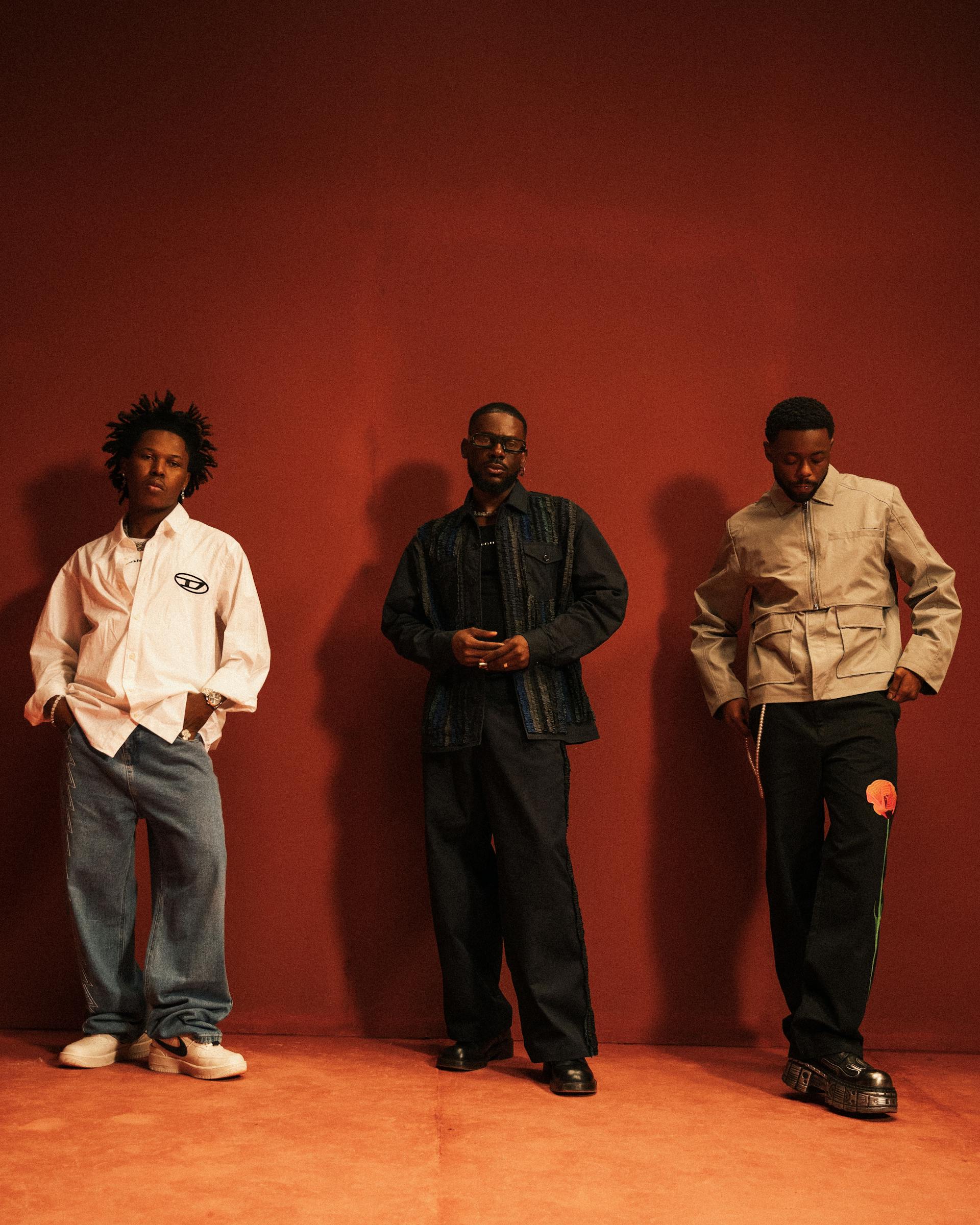 Three stylishly dressed Black men posing together