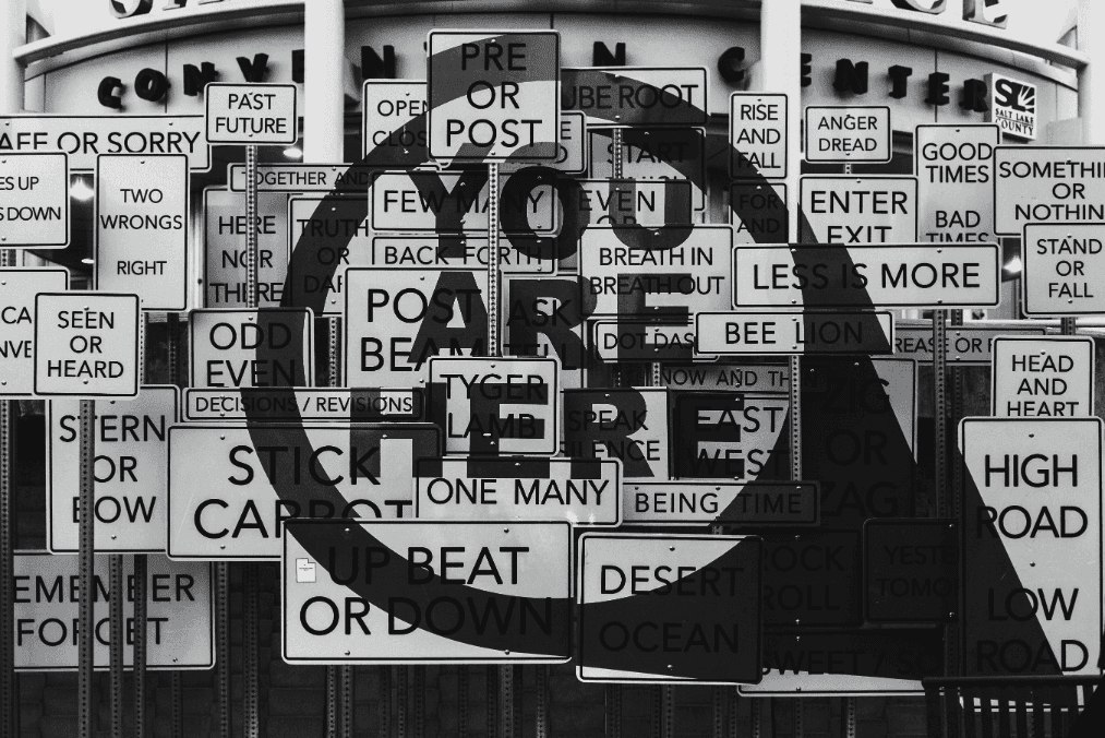 You are here sign with many other signs