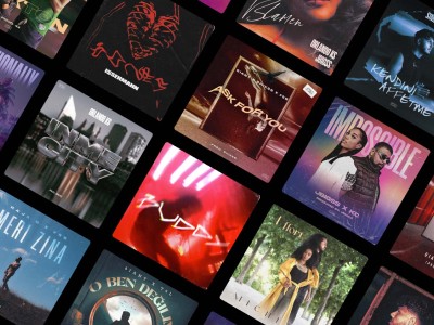 man wearing grey t-shirt standing in front of man sitting on chair