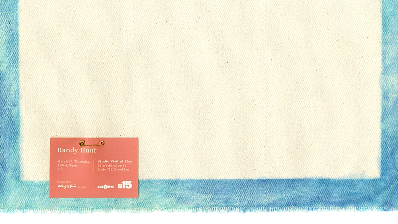 A poster depicting a piece of yellow paper with blue border, and attached to it is a orange label with white text.