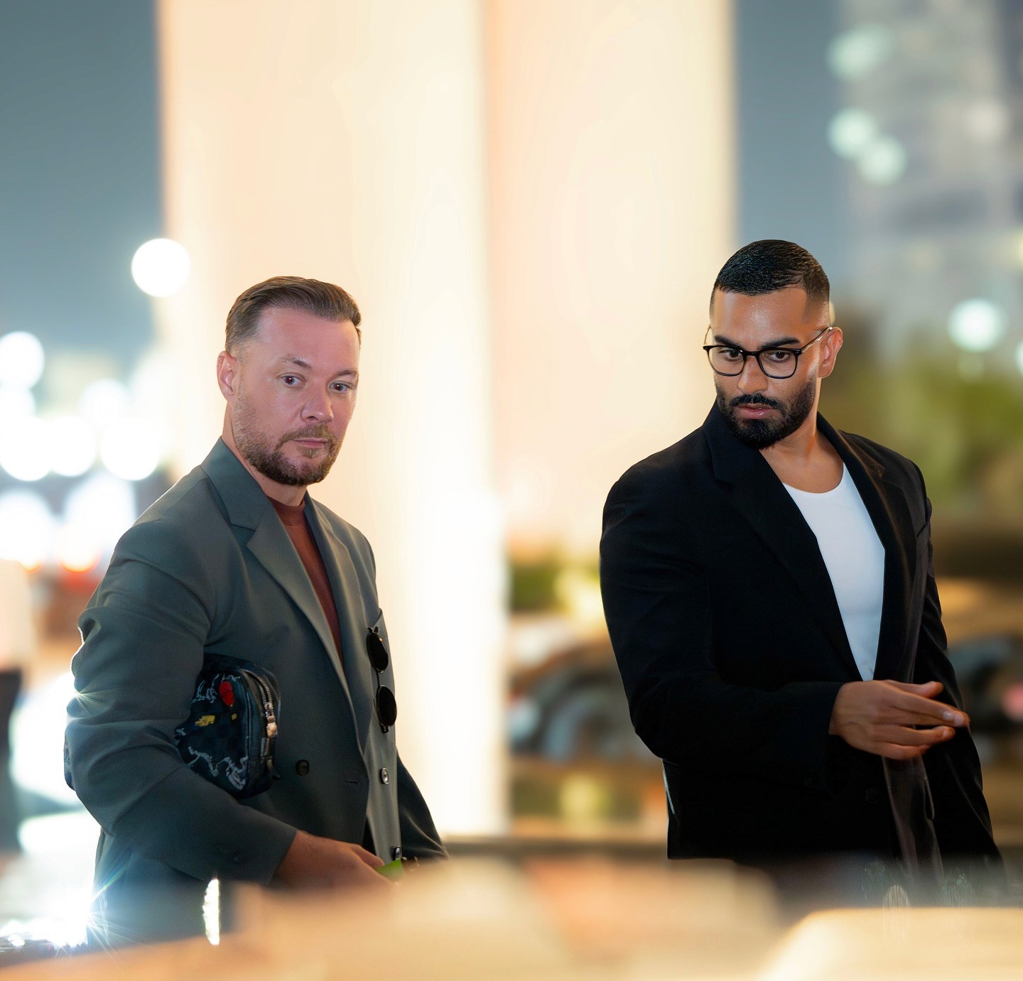Polaroid-style photo of a band performing, with drummer and guitarist behind a singer in a fringed outfit.