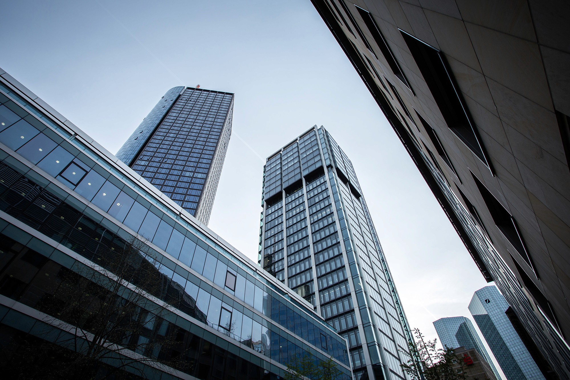 Low-angle view of modern high-rise buildings under a clear sky