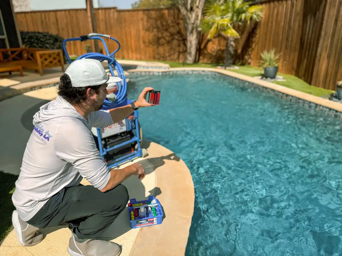 Poolside, TX pool technician by clean residential pool in Richardson