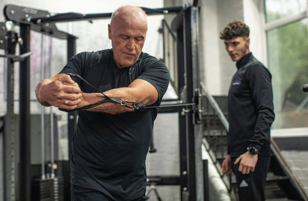 A man doing a pulley exercise showcasing the right way to increase muscle mass by Alchemy