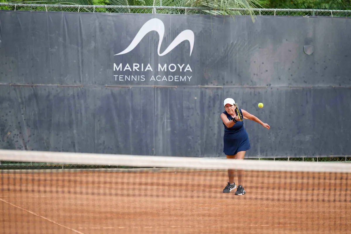 nfinity pool blending into the ocean view, minimalist sun loungers in soft neutral fabric, curved architecture