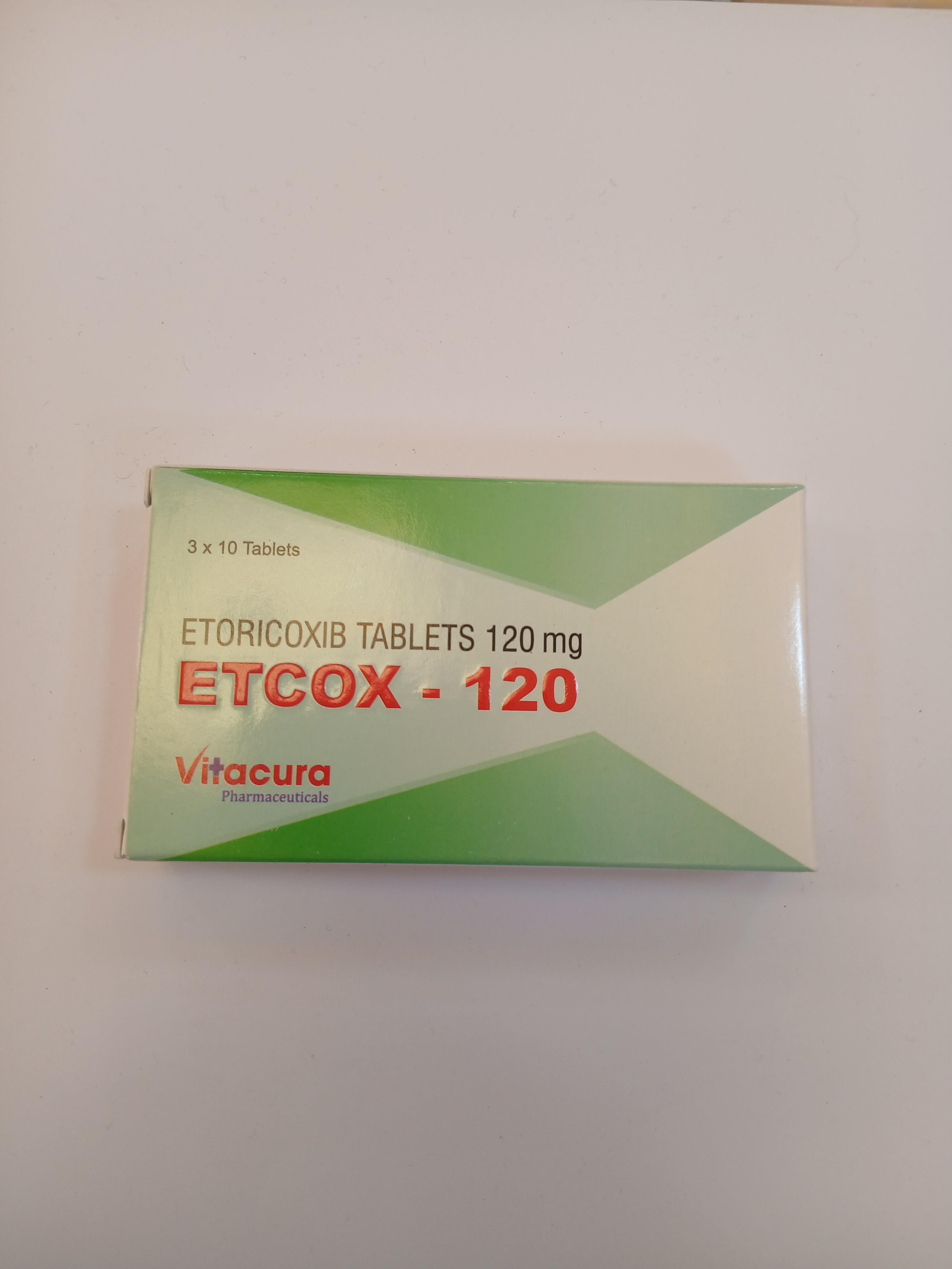 A white and green cardboard box packaging contains ten 120 mg tablets arranged in three rows, with printed text in red and black.