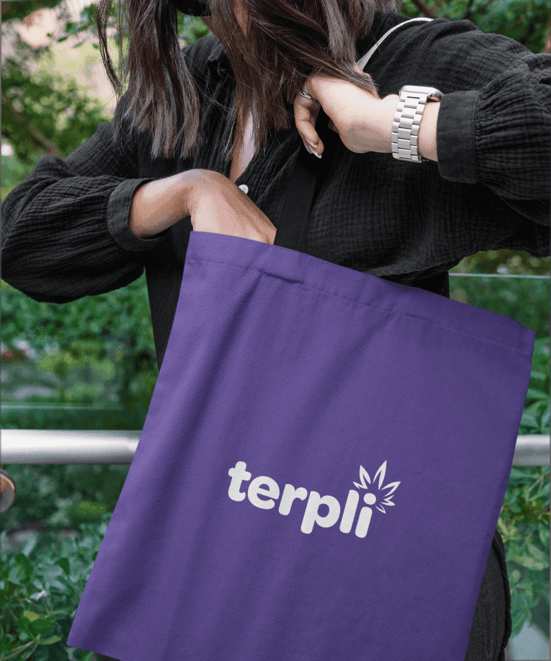 Brand Identity: Terpli AI Cannabis Retail platform logo design shown on a purple tote bag held by a woman, featuring white text and a cannabis leaf graphic.