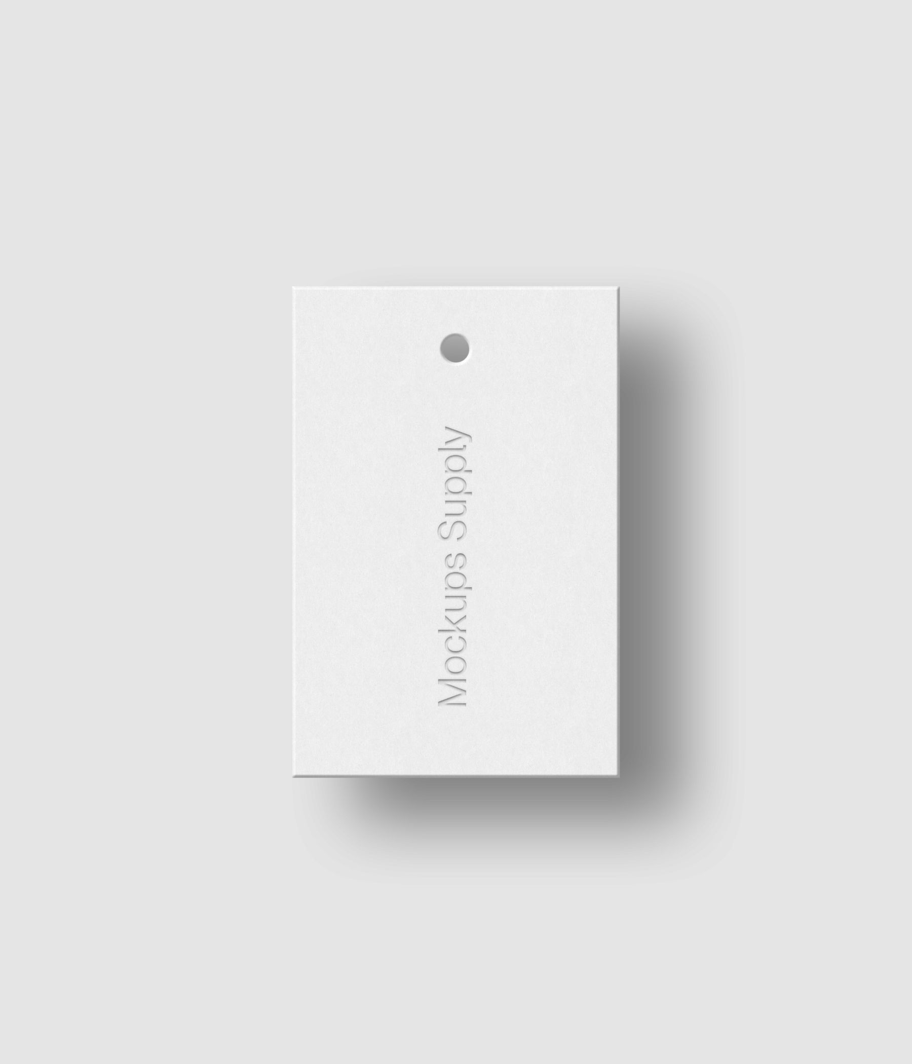 White 2x3 hang tag mockup on white background with realistic debossed logo effect and soft shadow for Photoshop download psd