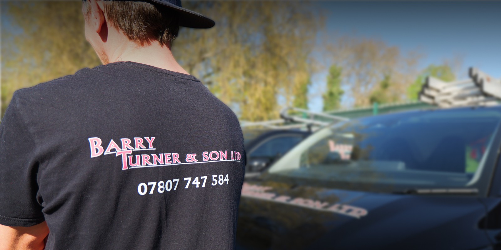 Image of team mate with his back facing the camera and Barry Turner and Son Logo on the back of the t-shirt