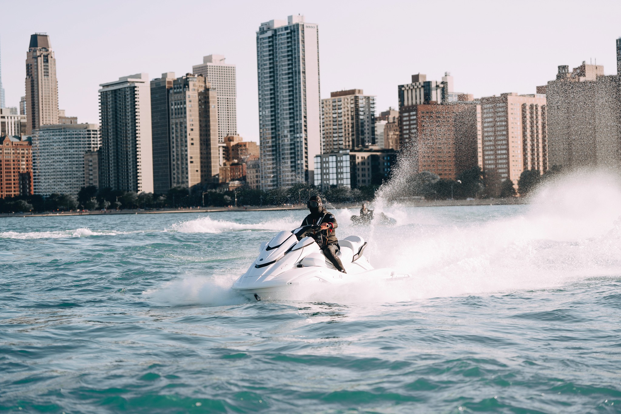 Lakeside experience poster with jet skis and skyline