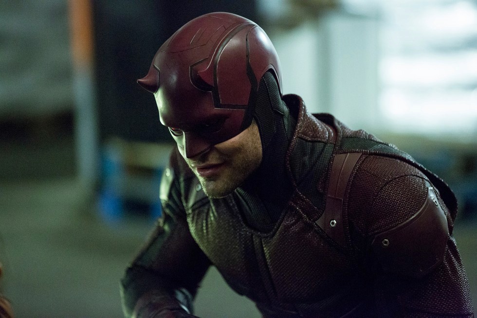 Daredevil in his red suit and mask, leaning forward with a focused expression.