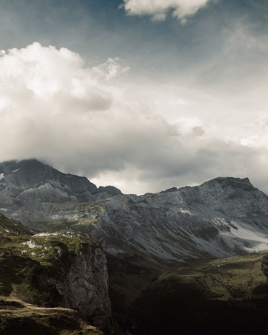 woman in brown long-sleeved top standing beside wall